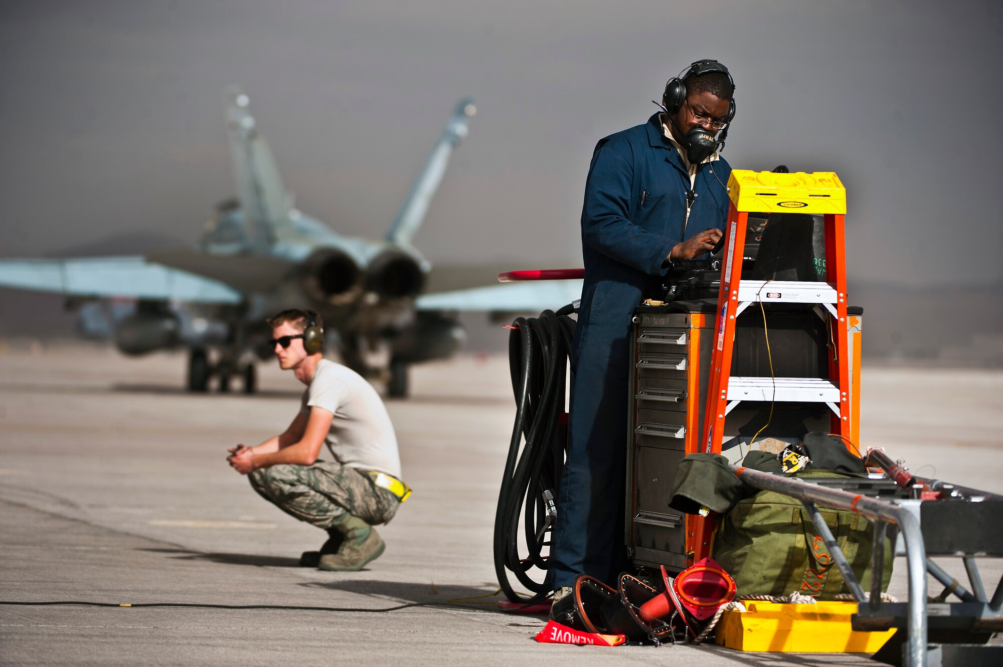 U.S. Air Force Staff Sgt. Tyrin Rush, 366th Aircraft Maintenance Squadron crew chief, Mountain Home Air Force Base, Idaho, looks at a technical order during Red Flag 14-1 Jan. 30, 2014, at Nellis AFB, Nev. Red Flag provides realistic combat training in a contested, degraded and operationally limited environment. This provides aircrews with real-time war scenarios and helps their ground crews also test their readiness capabilities. (U.S. Air Force photo/Senior Airman Brett Clashman)