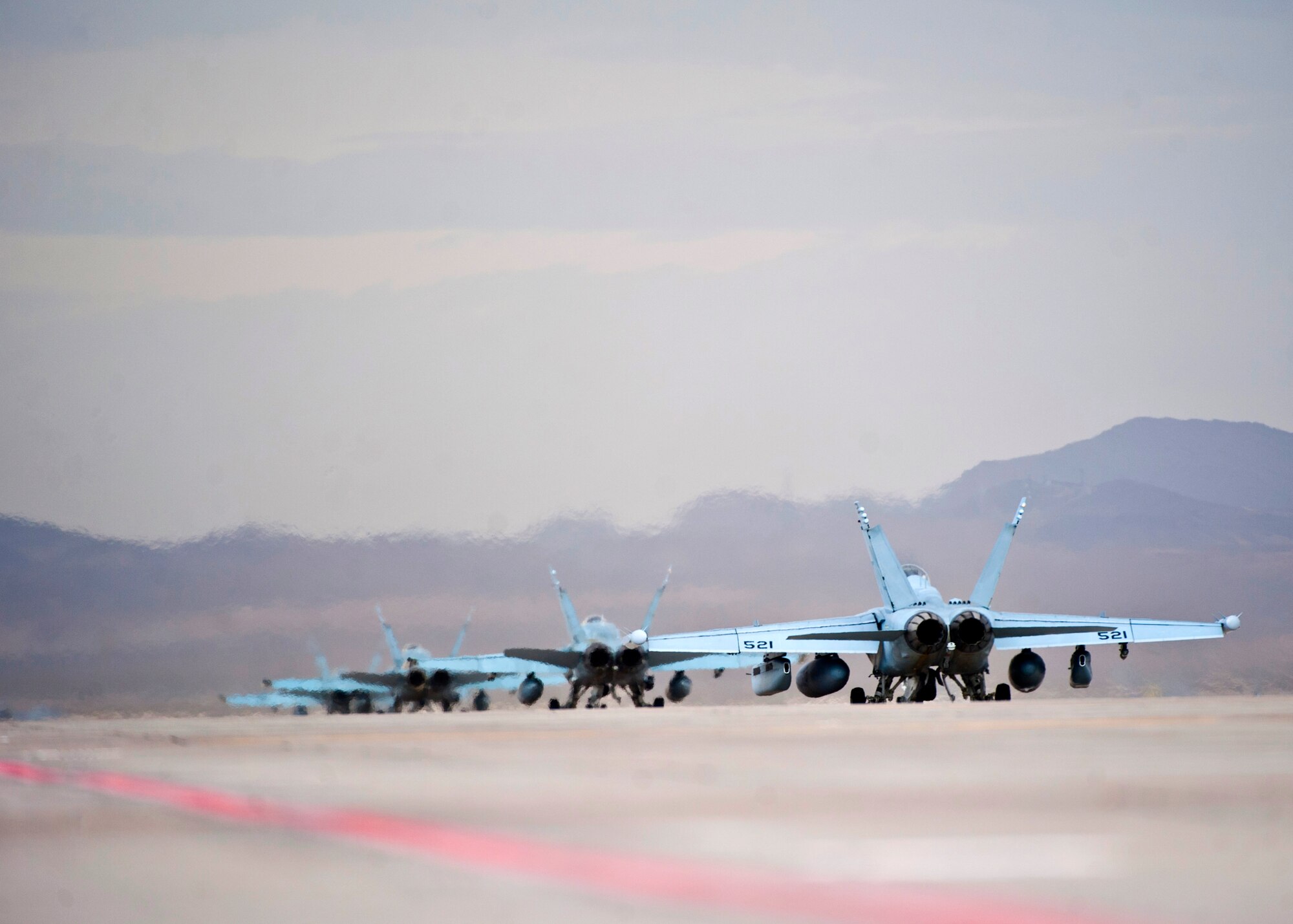 U.S. Navy Electronic Attack Wing Pacific, Electronic Attack Squadron 135 EA-18G Growlers taxi down the flightline during Red Flag 14-1 Jan. 30, 2014, at Nellis Air Force Base, Nev. The exercise is a realistic combat training exercise involving the air forces from the U.S. and its allies, and is conducted over the vast bombing and gunnery ranges of the 2.9-million acre Nevada Test and Training Range. (U.S. Air Force photo/Senior Airman Brett Clashman)