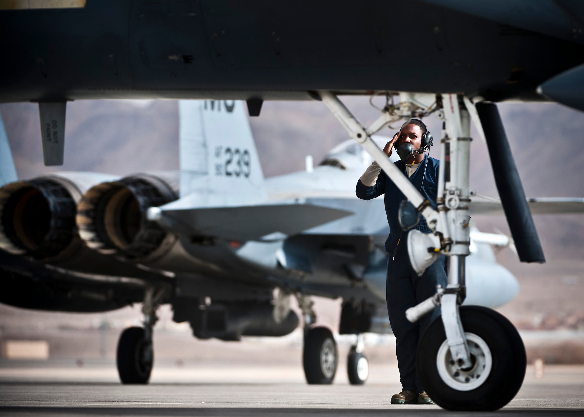 U.S. Air Force Senior Airman Oren Hemphill, 366th Aircraft Maintenance Squadron crew chief, Mountain Home Air Force Base, Idaho, salutes an F-15E Strike Eagle crew as he taxies out before his mission during Red Flag 14-1 Jan. 30, 2014, at Nellis Air Force Base, Nev. This exercise gives Airmen an opportunity to experience realistic combat scenarios to prepare and train them for future conflicts or war. (U.S. Air Force photo/Senior Airman Brett Clashman)