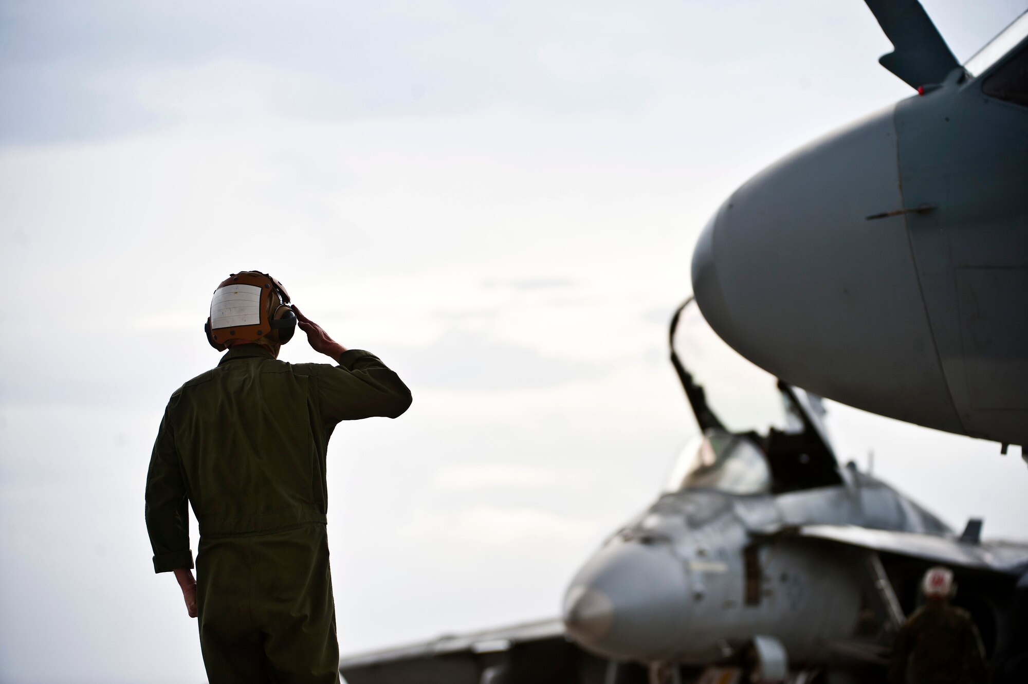 U.S. Marine Corps Gunnery Sgt. Kyle Smith, 2nd Marine Aircraft Wing, Marine Tactical Electronic Warfare Squadron 4 crew chief, renders a salute to an EA-6B Prowler crew prior to their take off during Red Flag 14-1 Jan. 30, 2014, at Nellis Air Force Base, Nev. The Prowler is a fully integrated electronic warfare system combining long-range, all-weather capabilities with advanced electronic countermeasures. More than 440,000 service members have participated in Red Flag since it began in 1975, including more than 145,000 aircrew members flying more than 385,000 sorties and logging more than 660,000 flight hours (U.S. Air Force photo/Senior Airman Brett Clashman)