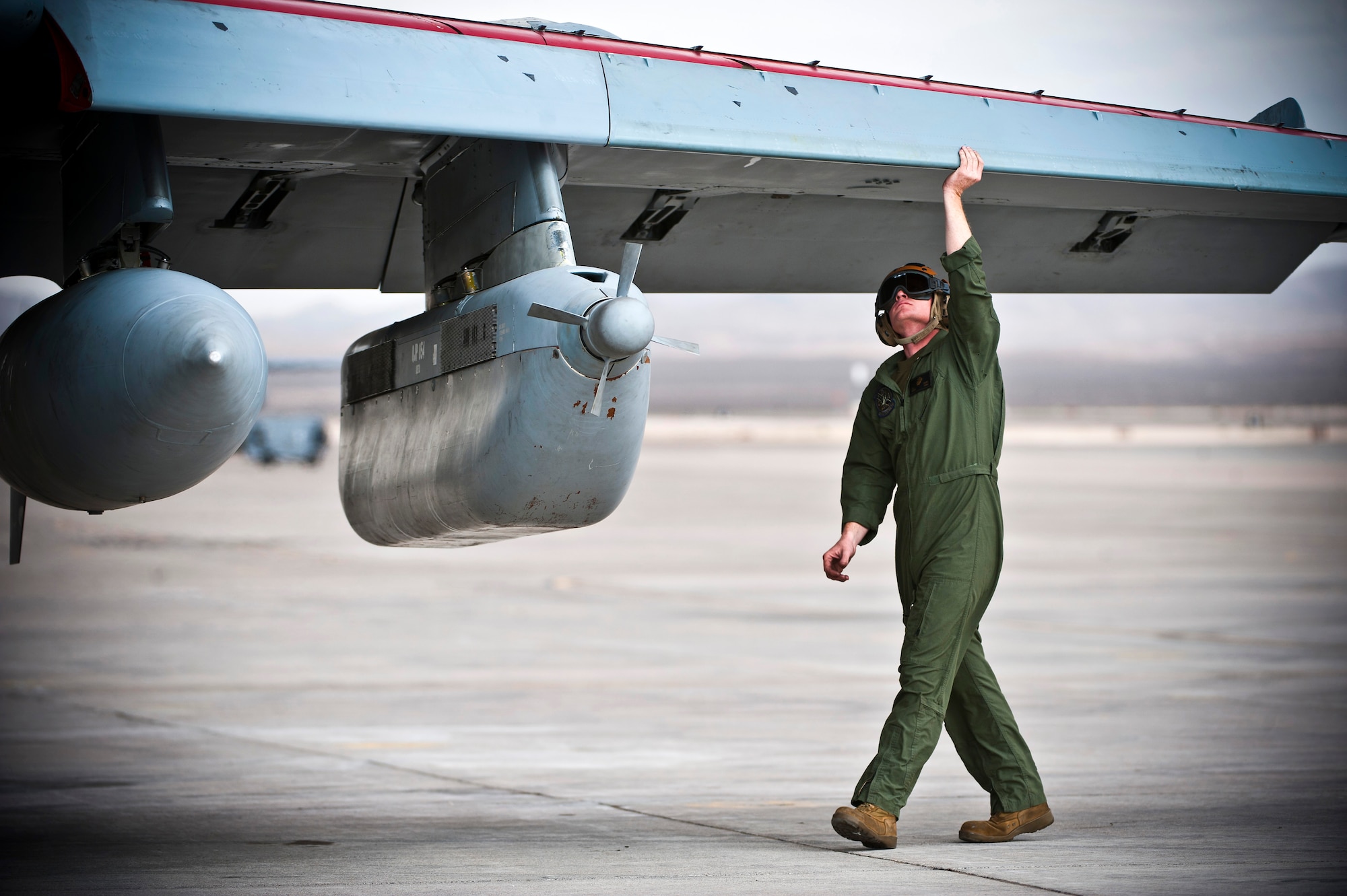 U.S. Marine Corps Sgt. Eric Swenson, 2nd Marine Aircraft Wing, Marine Tactical Electronic Warfare Squadron 4 point checker, inspects underneath the wing of an EA-6B Prowler during Red Flag 14-1 Jan. 30, 2014, at Nellis Air Force Base, Nev. Red Flag gives aircrews and air support operations members from various airframes, military services and allied countries an opportunity to integrate and practice combat operations. (U.S. Air Force photo/Senior Airman Brett Clashman)