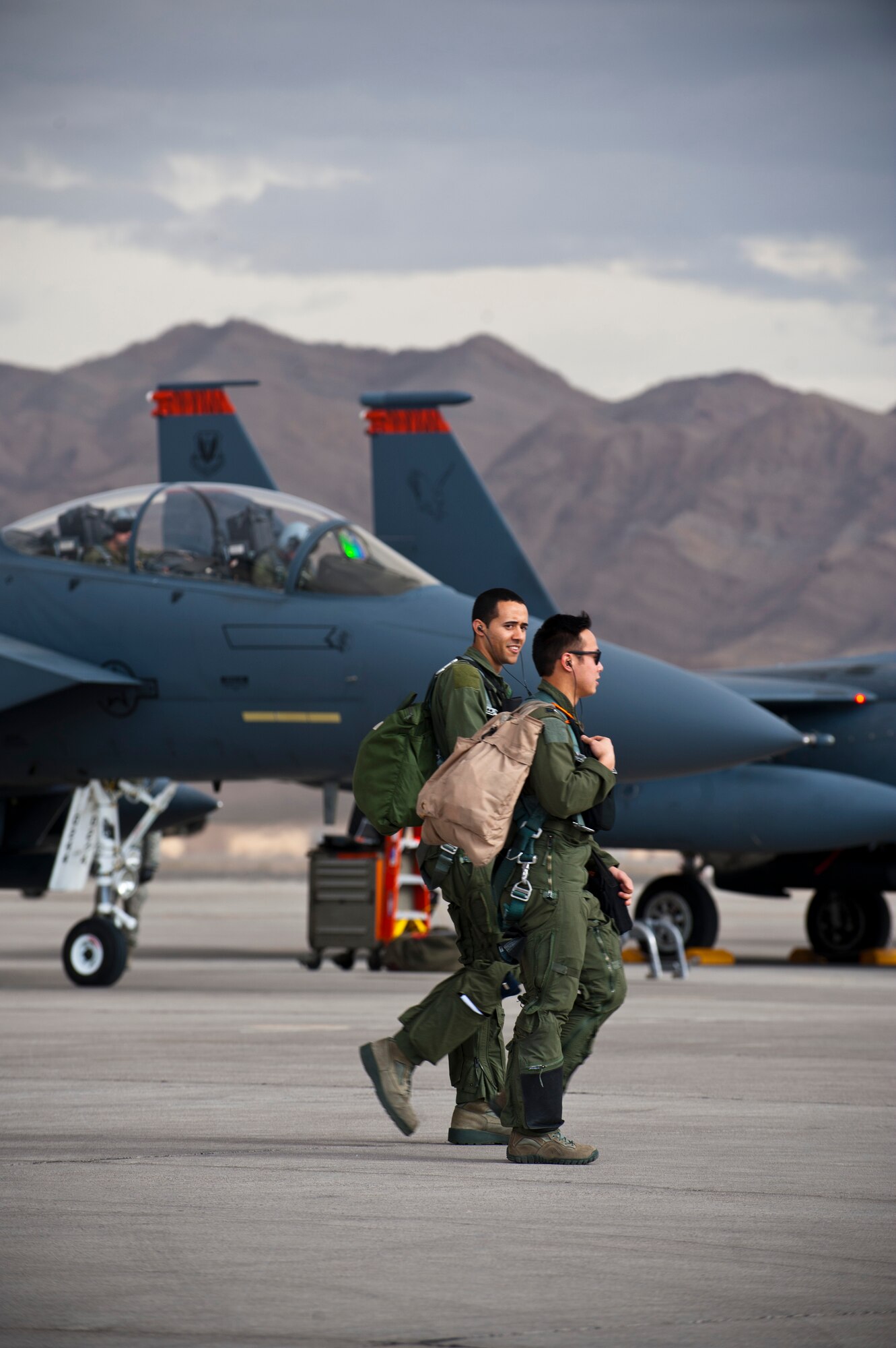 A U.S. Air Force F-15E crew assigned to the 391st Fighter Squadron from Mountain Home Air Force Base, Idaho, walk to their aircraft during Red Flag 14-1 Jan. 30, 2014, at Nellis AFB, Nev. Red Flag is a realistic combat training exercise involving all four branches of the U.S. military and U.S. allies. Air-to-air combat training exercises are conducted over the 2.9 million acre Nevada Test and Training Range during Red Flag. (U.S. Air Force photo by Airman 1st Class Thomas Spangler)