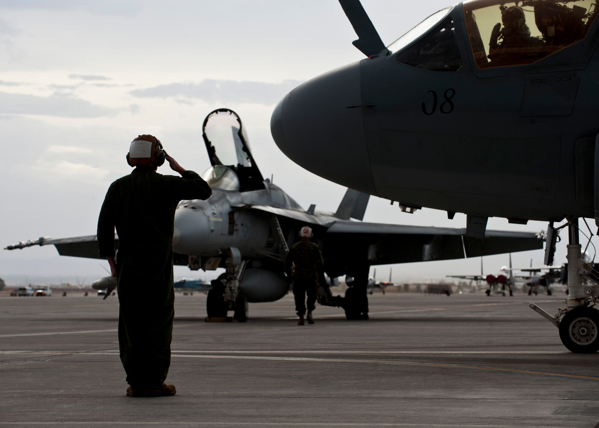 U.S. Marine Corps Plane Captain Gunnery Sgt. Kyle Smith, 2nd Marine Aircraft Wing, Marine Tactical Electronic Warfare Squadron 4, salutes the pilot of an EA-6B Prowler assigned to 2nd MAW from Marine Corps Air Station Cherry Point, N.C., as it taxis to the runway during Red Flag 14-1 Jan. 30, 2014, at Nellis Air Force Base, Nev. Red Flag gives aircrews and maintainers from different branches and allied nations the opportunity to practice realistic combat operations which will prepare them for potential real-world conflicts and wars. (U.S. Air Force photo by Airman 1st Class Thomas Spangler)