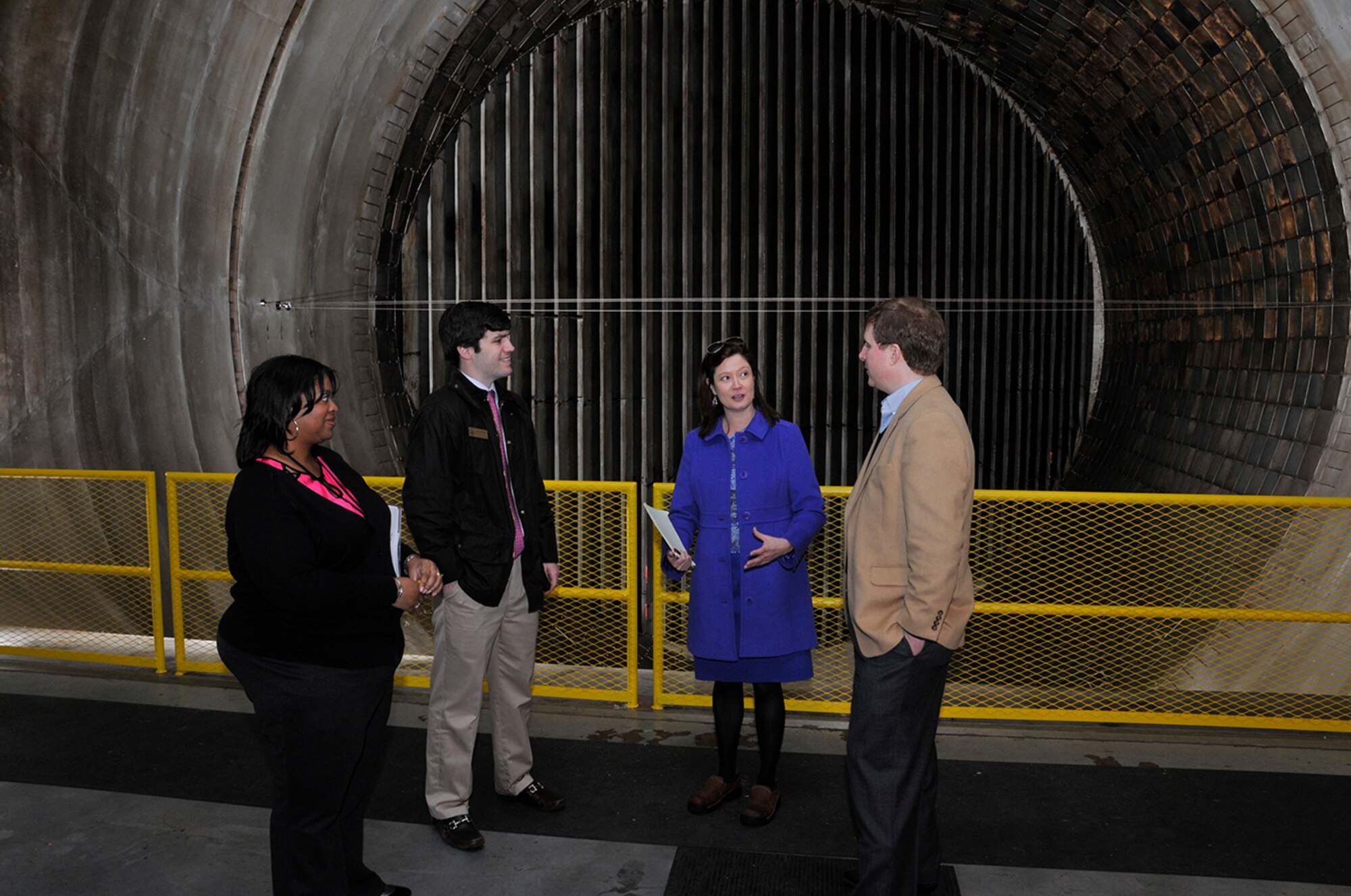 Kathy Gattis (2nd from right), the Aerospace Testing Alliance (ATA) Public Affairs manager, describes the types of customers Arnold Engineering Development Complex (AEDC) supports when testing in the Propulsion Wind Tunnel Test branch to visiting Congressman Diane Black staffers, Charles Schneider (right) and Wills Gardner (2nd from left). (Photos by Rick Goodfriend)