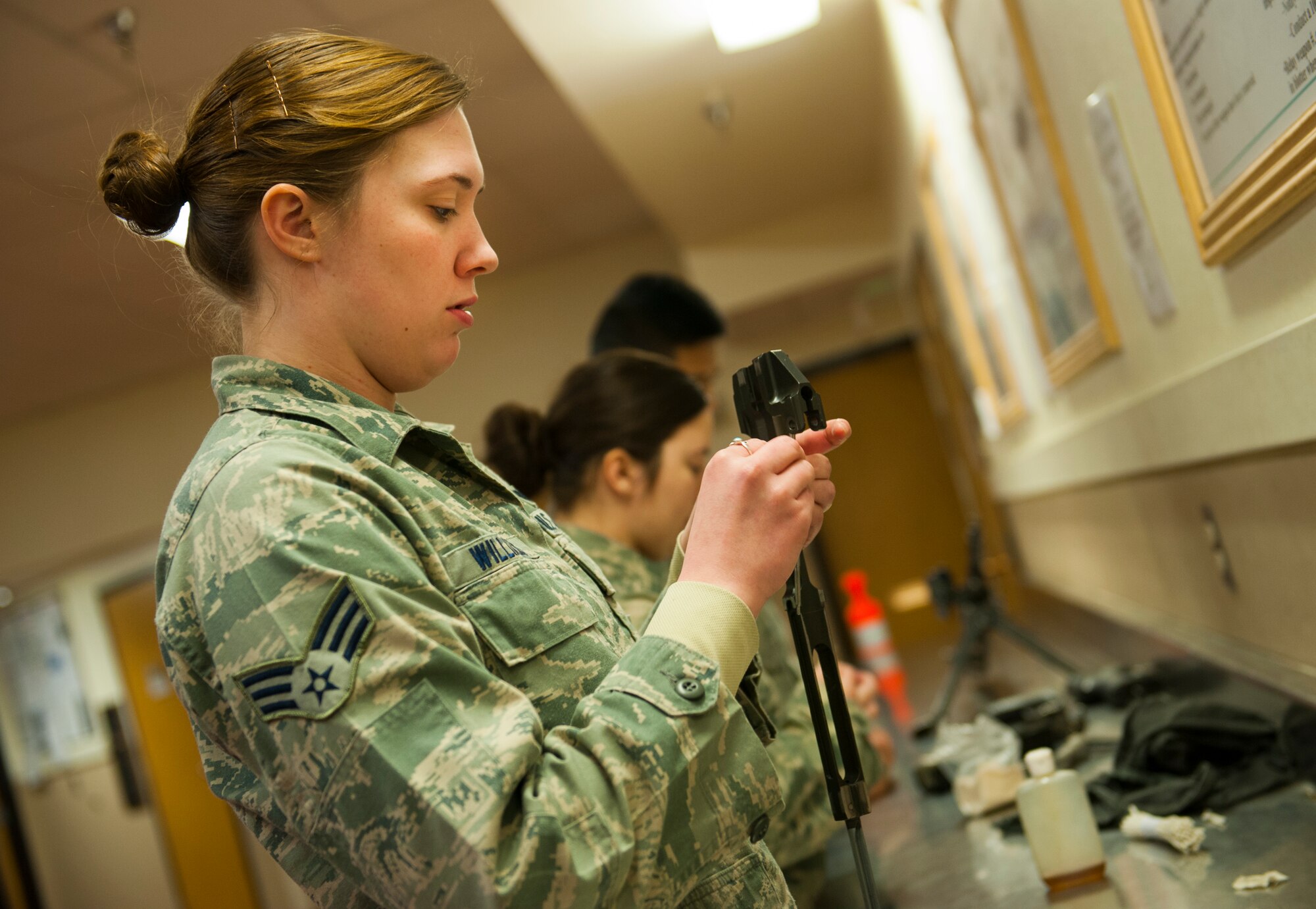 Senior Airman Jessica Williams, 5th Security Forces Squadron defender, polishes a weapon at Minot Air Force Base, N.D., Jan. 30, 2014. Security forces Airmen are required to clean weapons once a month. (U.S. Air Force photo/Airman 1st Class Apryl Hall)