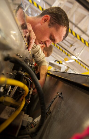 Senior Airman Brett Randolph, 5th Logistics Readiness Squadron fire truck maintainer, works on a fire truck at the Minot Air Force Base fire house, Jan. 28, 2014. Vehicle mechanics at Minot AFB maintain the government vehicles at 11 different facilities across base. (U.S. Air Force photo/Airman 1st Class Apryl Hall)