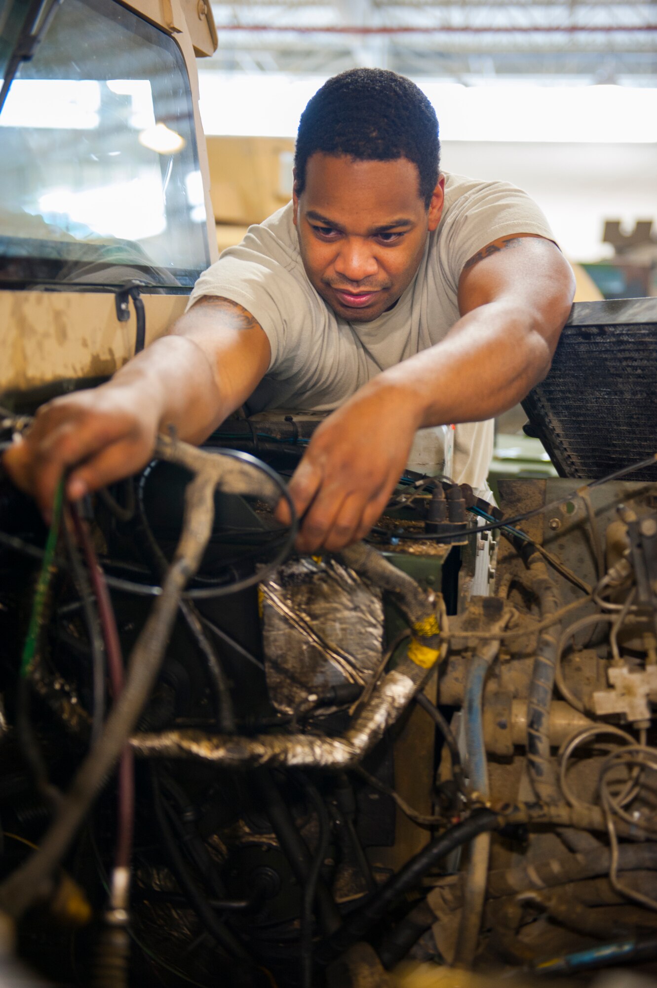 Staff Sgt. Aaron Hardy, 5th Logistics Readiness Squadron vehicle mechanic, works on the wiring of a Humvee at Minot Air Force Base’s Defender Dome, Jan. 28, 2014. Vehicle mechanics are responsible for the maintenance of all the government-owned vehicles on base. (U.S. Air Force photo/Airman 1st Class Apryl Hall)