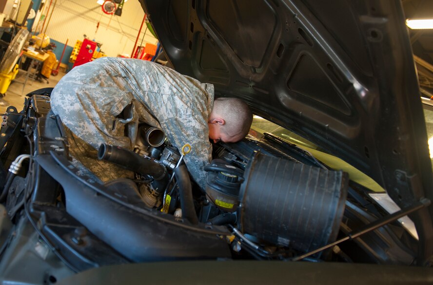 A 5th Logistics Readiness Squadron vehicle mechanic fixes a truck at Minot Air Force Base, N.D., Jan. 28, 2014. Vehicle mechanics maintain all government-owned vehicles from sedans to fire trucks. (U.S. Air Force photo/Airman 1st Class Apryl Hall)