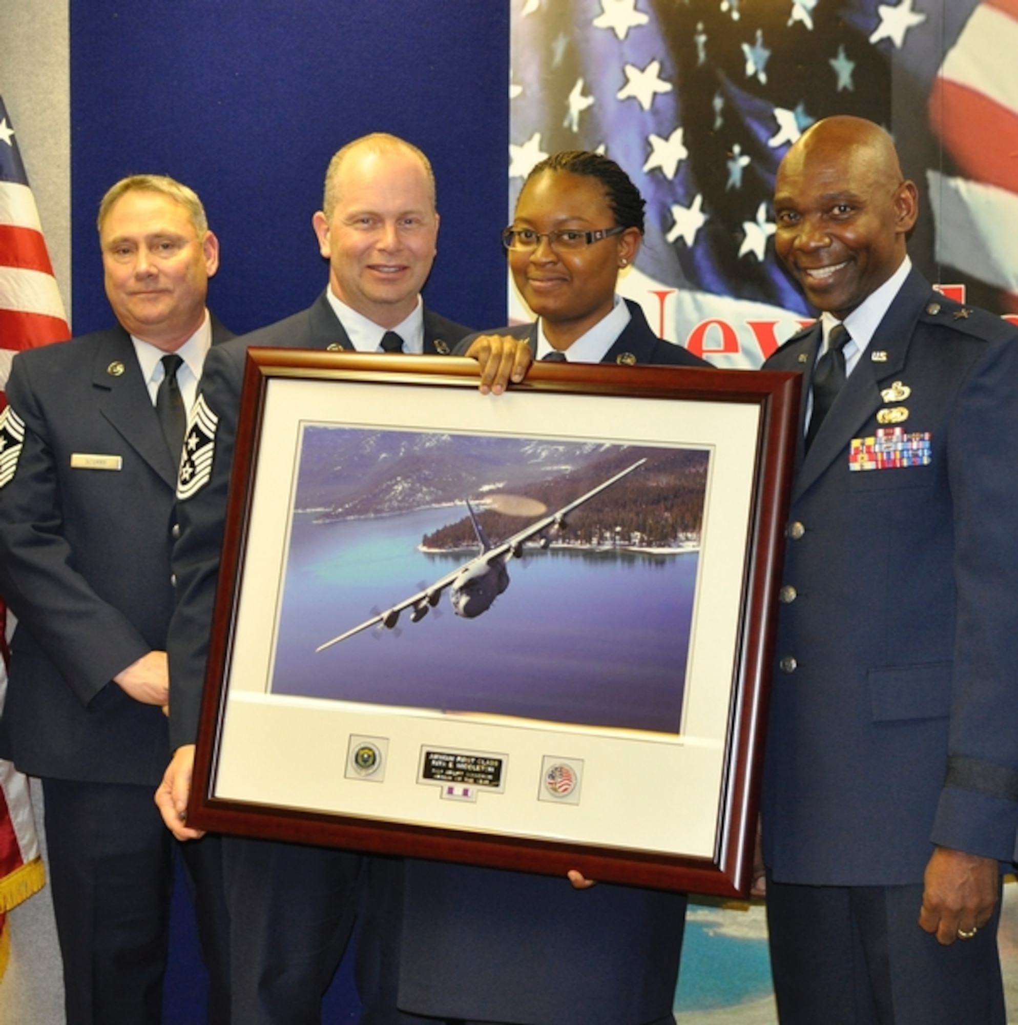 Airman 1st Class Rita Middleton, third from left, receives her Airman of the Year award at the Nevada Air National Guard base in Reno on January 25. Officials presenting the award included, from left, Command Chief Master Sgt. Rick Scurry, Command Chief Master Sgt. of the Air National Guard James Hotaling, and Brig. Gen. Ondra Berry.  (NV ANG photo by Senior Airman Ashif Halim/Released)