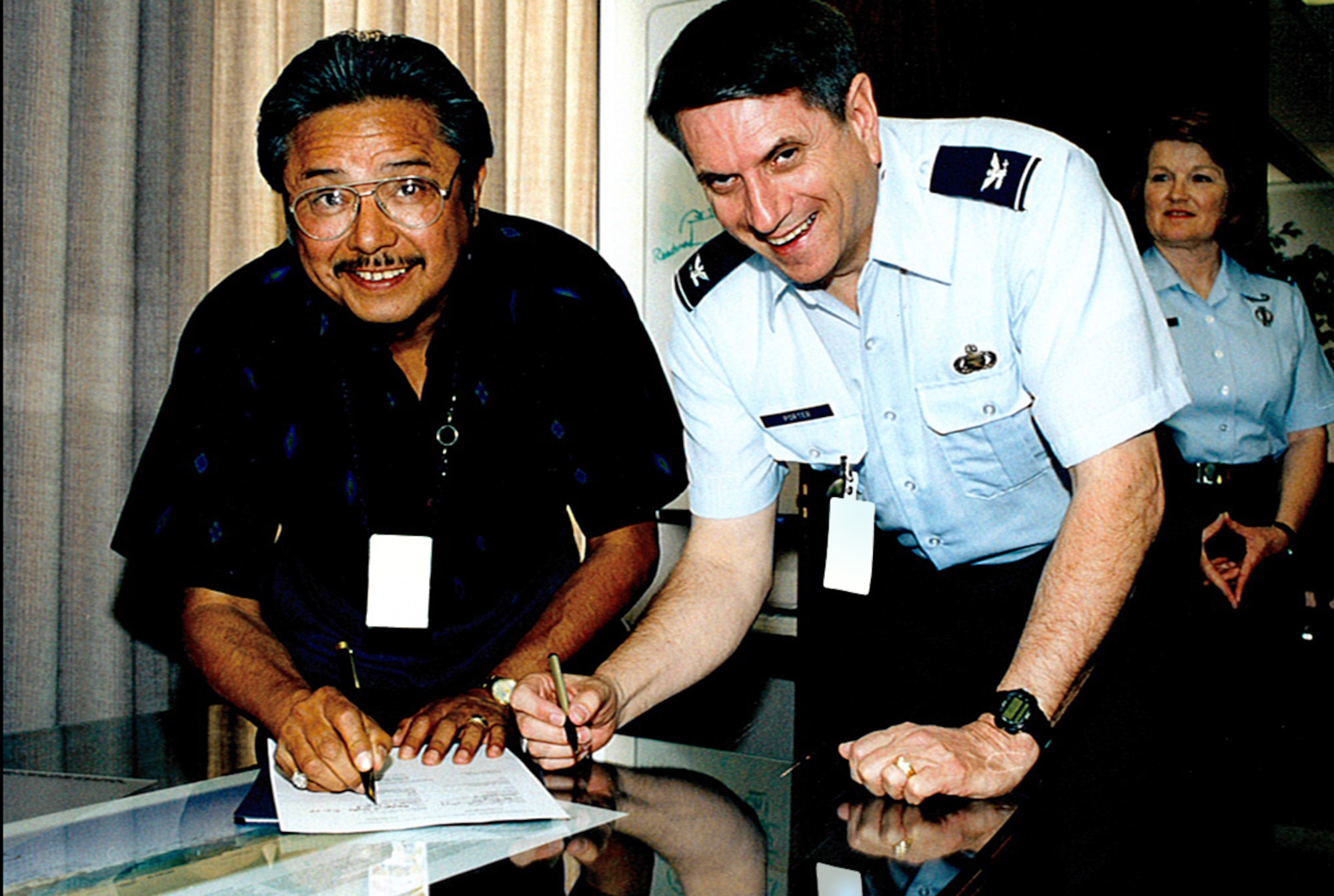 BUCKLEY AIR FORCE BASE, Colo. -- Air Reserve Personnel Center Union President Roberto Trinidad and vice commander Col. Rett Porter prepare to sign a document while commander Col. Marge Humphrey looks on. (Historical photo)