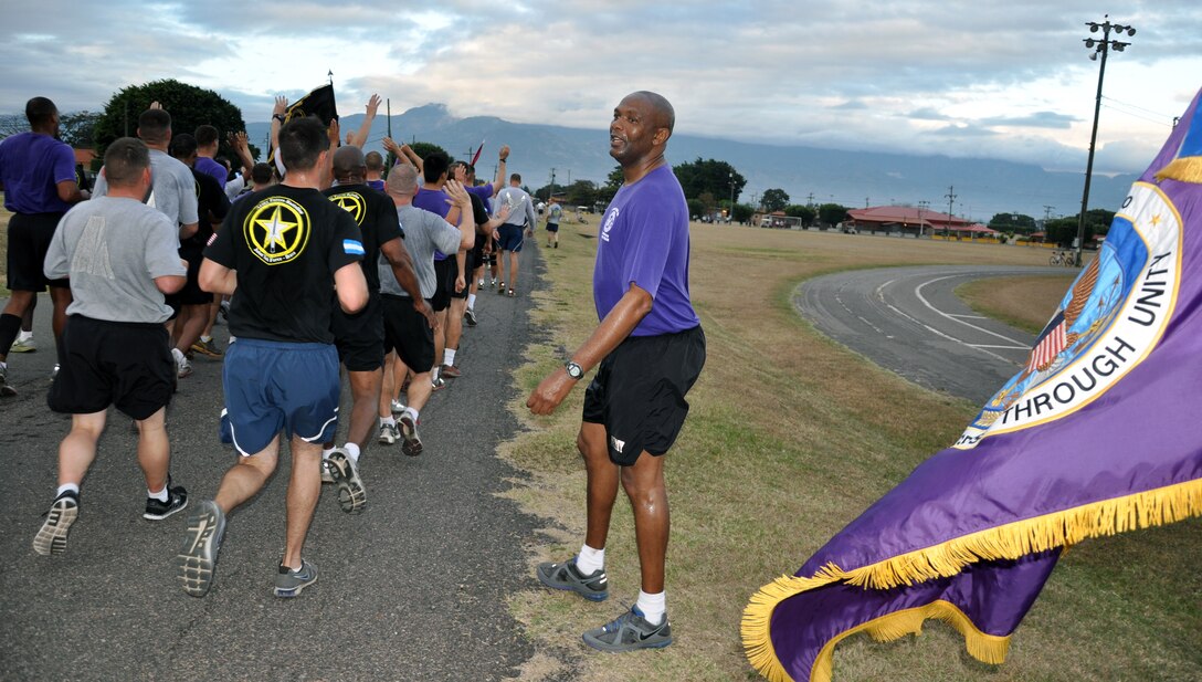 Joint Task Force-Bravo Command Sgt. Maj. Valmond A. Martin gives encouragement to runners at the conclusion of a formation run conducted in his honor at Soto Cano Air Base, Honduras, Jan. 31, 2014. Martin, who enlisted in the U.S. Army in 1983, is retiring after more than 31 years of service. The event marked the final formation run of the Command Sergeant Major’s career. (U.S. Air Force photo by Capt. Zach Anderson) 