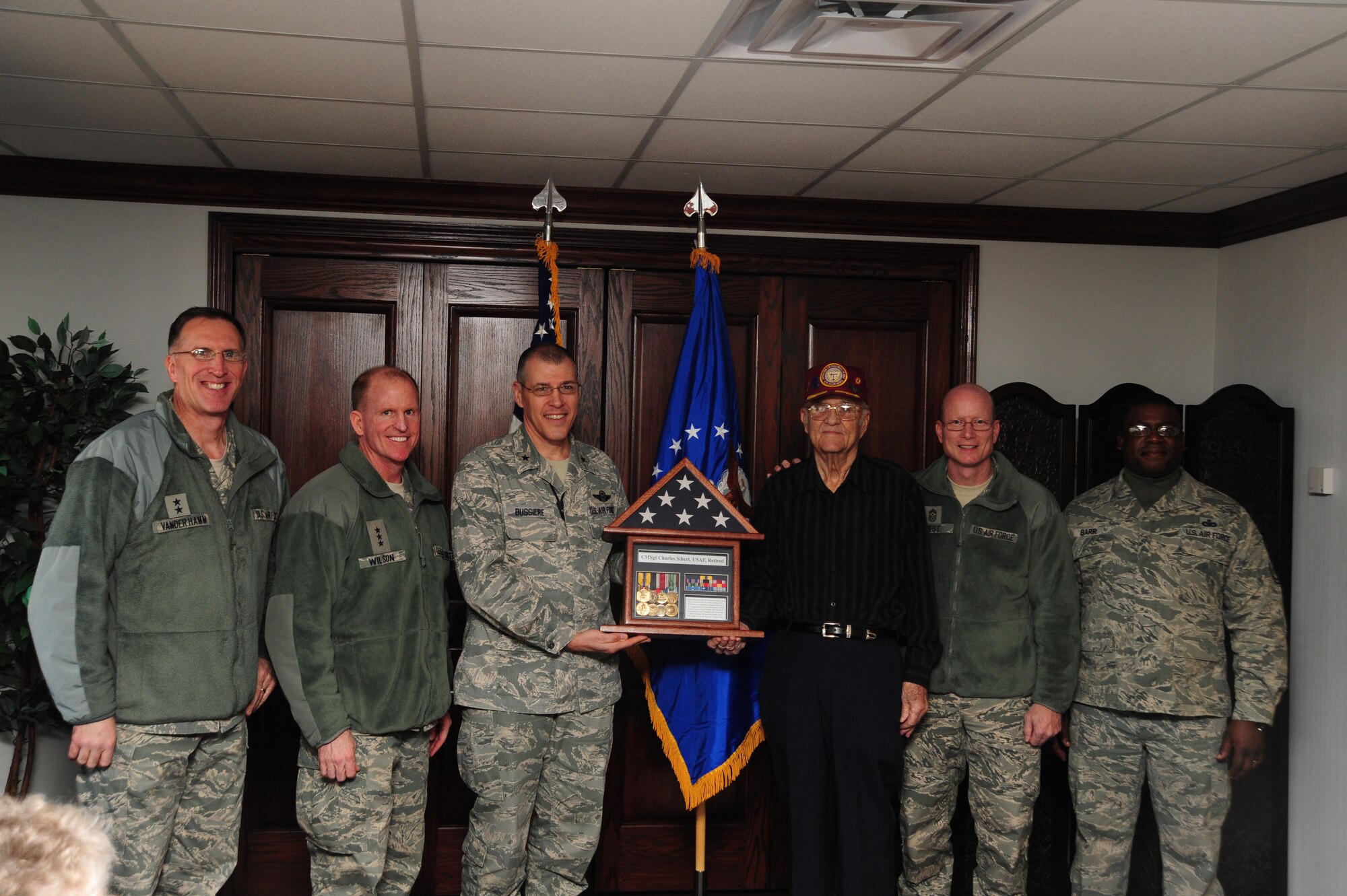 Maj. Gen. Scott Vander Hamm, 8th Air Force commander; Lt. Gen. Stephen Wilson, commander of Air Force Global Strike Command; Brig. Gen. Thomas Bussiere, 509th Bomb Wing commander; Chief Master Sgt. Terry West, 8th AF commmand chief; and Chief Master Sgt. Lee Barr, 509th BW command chief, present retired Chief Master Sgt. Charles Sibert with a shadowbox commemorating his service and accomplishments, Whiteman Air Force Base, Mo., Jan. 24, 2014. The ceremony provided leadership the chance to officially recognize Sibert's outstanding service to the nation during his time as an Airman. (U.S. Air Force photo by Staff Sgt. Nick Wilson/Released)