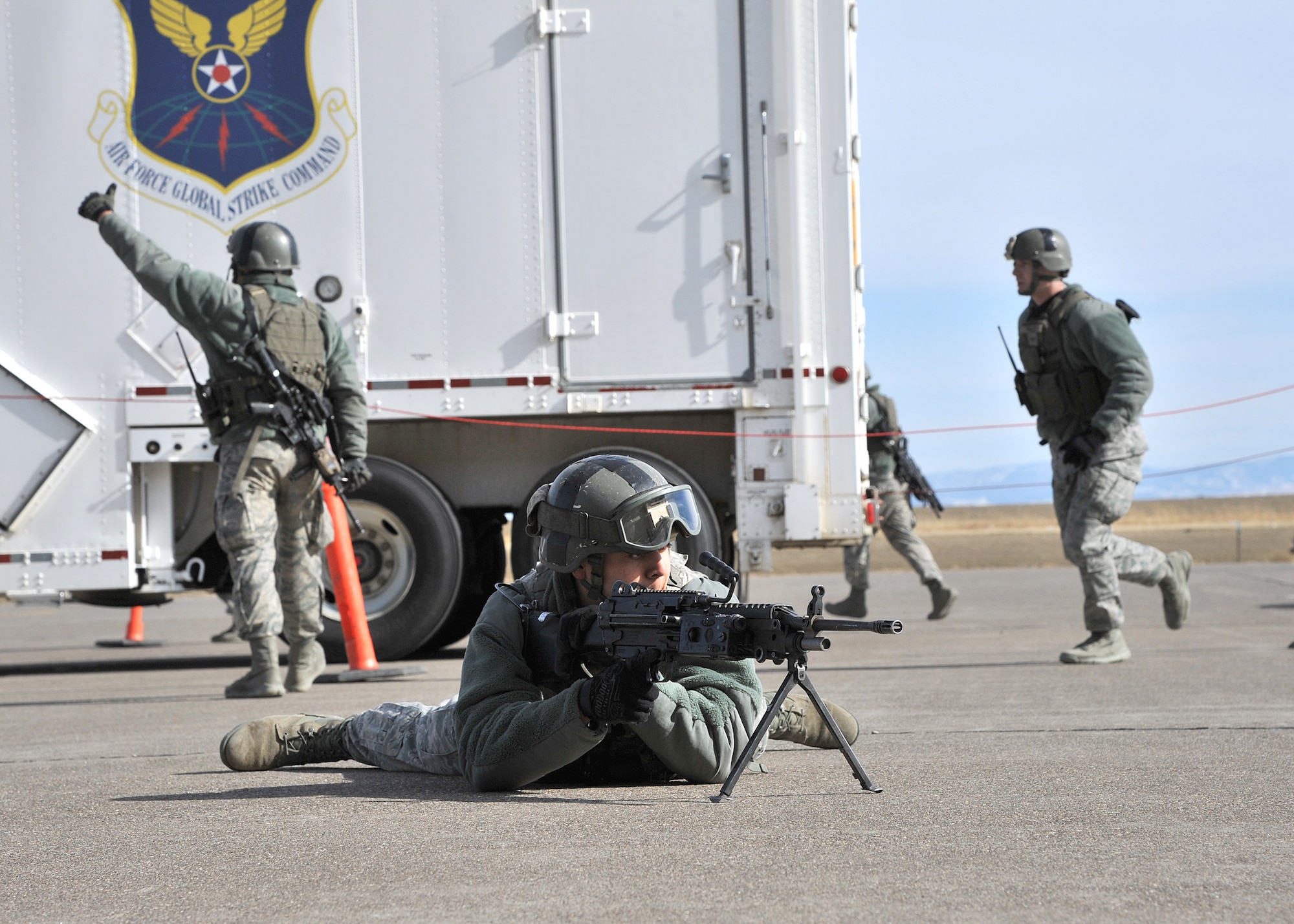 Airmen from the 741st Missile Security Forces Squadron perform a convoy response force exercise as part of a demonstration for Brig. Gen. James Browne, then Air Force Global Strike Command director of operations, in March 2012. The Airmen simulating this exercise must all be up on their PRP status due to the nature of their job. (U.S. Air Force photo/John Turner)