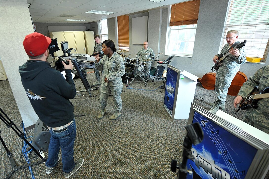 U.S. Air Force Senior Airman Paula Hunt performs with her band, Raptor, for a television segment on the Omaha auditions episode of American Idol. Hunt auditioned for American Idol in the episode that aired Jan. 30 and received three yeses from the judges, ensuring her a ticket to Hollywood Week. (Photo by Charles Haymond)