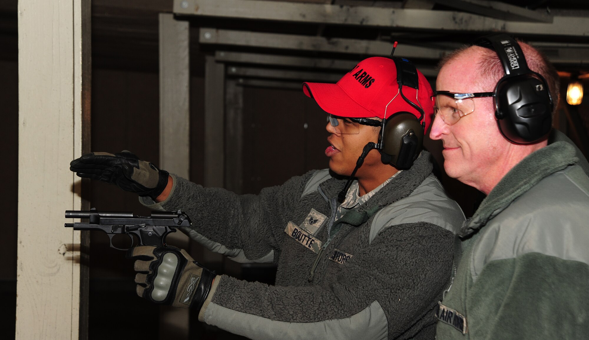 Staff Sgt. Michael Boutte, 509th Security Forces assistant NCO in charge of combat arms, briefs M9 firing instructions to Lt. Gen. Stephen Wilson, commander of Air Force Global Strike Command, during a visit to Whiteman Air Force Base, Mo., Jan. 24, 2014. Air Force Global Strike leadership visited Team Whiteman to congratulate them on a job well done during a recent Nuclear Surety Inspection. (U.S. Air Force photos by Staff Sgt. Nick Wilson/Released)