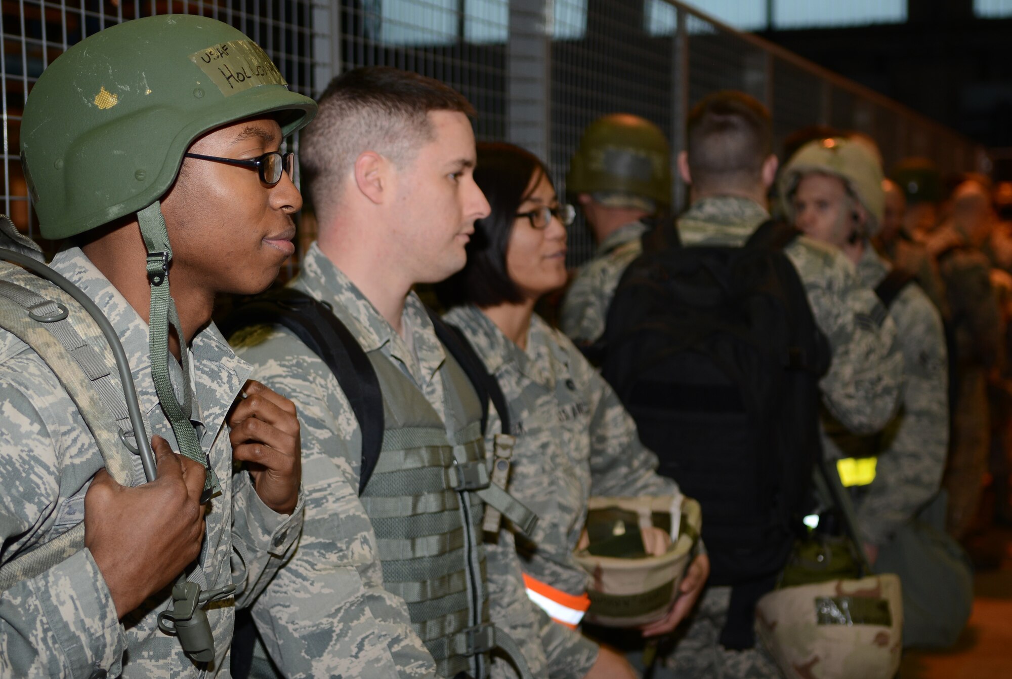 Team Mildenhall members wait to be called into a briefing room Jan. 30, 2014, during a deployment exercise on RAF Mildenhall, England. While moving through a pre-deployment facility, representatives from each on-base agency culminate in one room to quickly and effectively give briefings. The exercise, part of a base-wide operational readiness inspection, focused on assessing the base’s preparedness for real-world operations. (U.S. Air Force photo by Airman 1st Class Dillon Johnston/Released)