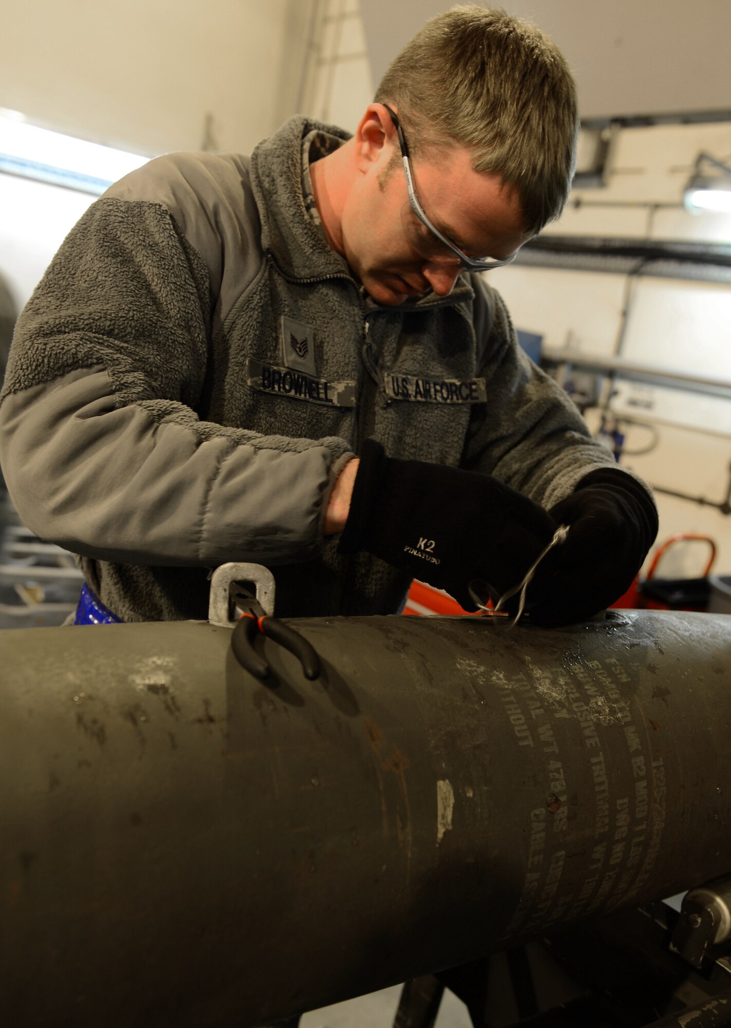 Staff Sgt. Gregory Brownell, 48th Munitions Squadron dedicated crew chief, wires a GBU-12 laser-guided bomb on Royal Air Force Lakenheath, England, Jan. 29, 2014. The 48th MUNS Airmen are building the 500-pound bombs in preparation for an upcoming exercise. (U.S. Air Force photo by Airman 1st Class Dawn M. Weber/Released)
