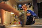 Karl Leonard, Joint Base San Antonio-Randolph Health and Wellness Center exercise physiologist, studies Robert Calmes’ footwork during a natural running clinic appointment Jan. 21 at the JBSA-Randolph HAWC. (U.S. Air Force photo by Airman 1st Class Kenna Jackson)