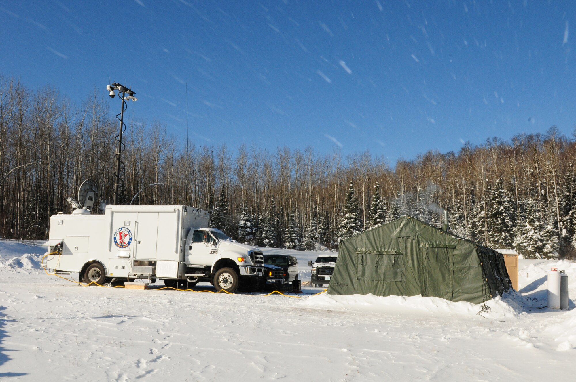 U.S. Airmen, 148th Fighter Wing, Communications Flight made camp and set-up communications at this remote location northwest of Grand Marais, Minn., Jan. 28, 2014.  The Airmen are part of the Deployable Interoperable Communications Element (DICE) team and were at the remote location to provide communication support for the John Beargrease sled dog marathon.  (U. S. Air National Guard photo by Master Sgt. Ralph J. Kapustka/Released)  