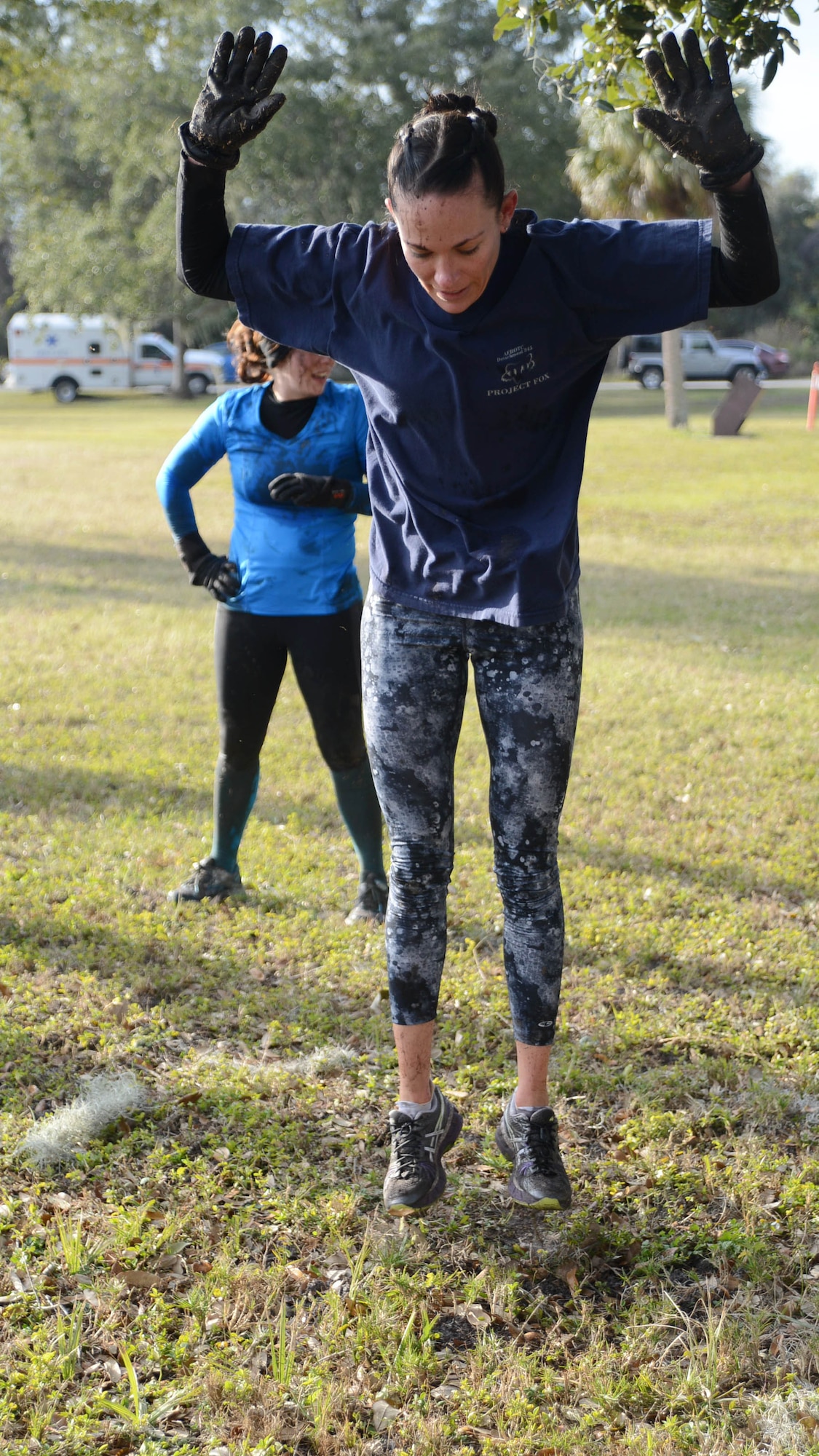 A participant of the Team MacDill Gladiator Assualt Challenge performs a burpee Jan.  24, 2014 at MacDill Air Force Base, Fla. The challenge consisted of three 5k runs, barricades, mud pit, bear crawl, human wheel barrel, latters, and rock climbing along with various physical fitness exercises. (U.S. Air Force phot by Senior Airman Jenay Randolph/Released)