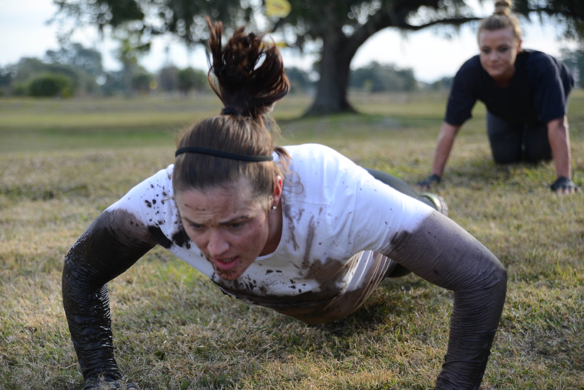 Tech. Sgt. Stephanie Riseboro, 6th Aerospace Medicine Squadron bioenvironmental engineer, performs pushups during the Gladiator Assault Challenge, Jan. 24, 2014 at MacDill Air Force Base, Fla. The challenge consisted of three 5k runs, barricades, mud pit, bear crawl, human wheel barrel, latters, and rock climbing along with various physical fitness exercises. (U.S. Air Force photo by Senior Airman Jenay Randolph/Released)