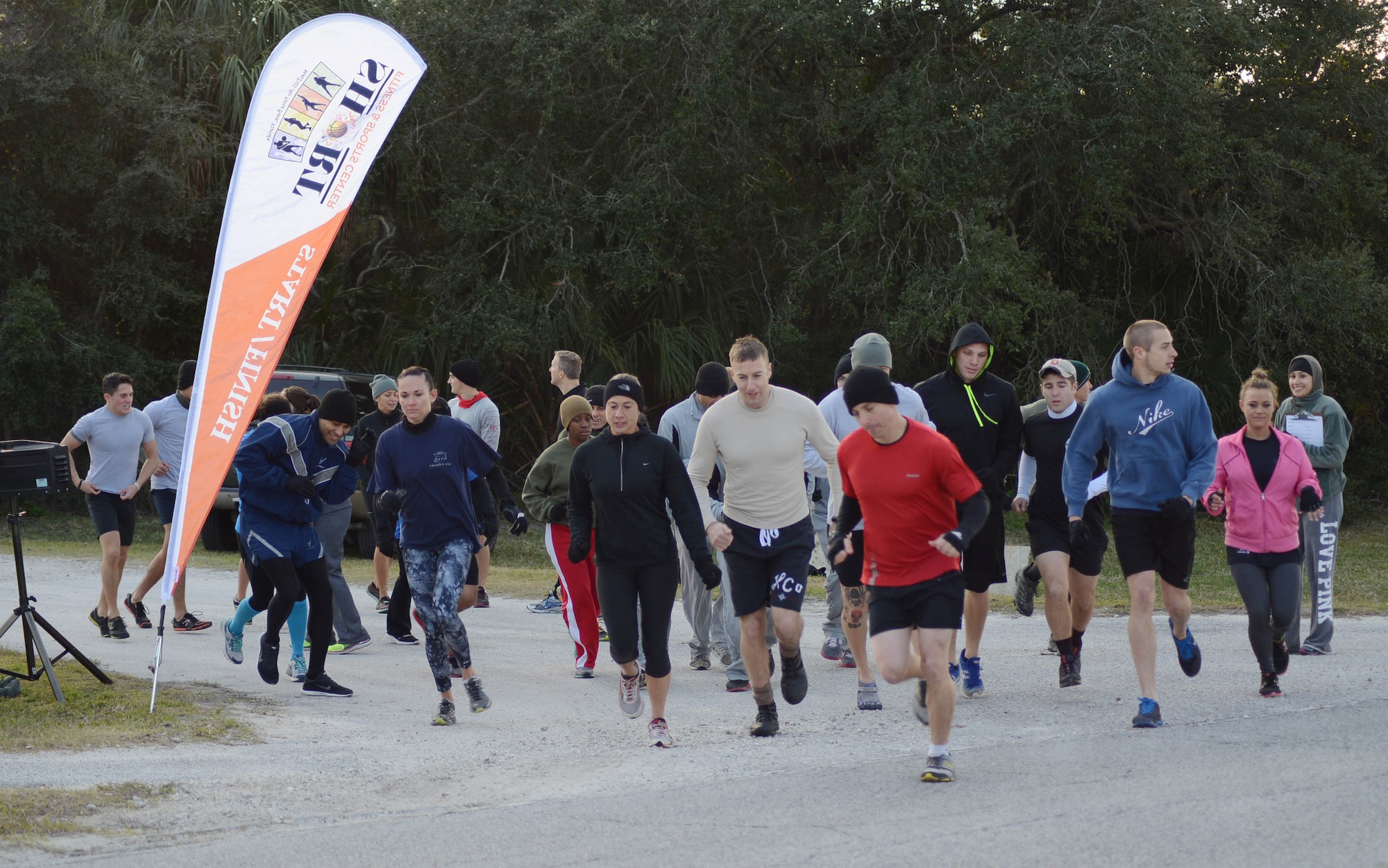 Members of Team MacDill participate in a Gladiator Assault Challenge Jan. 24, 2014 at MacDill Air Force Base, Fla.The challenge is a 9.6 mile mix of outdoor obstacles and combined maneuvers planned to test endurance, speed, strength and agility with runs, crawls and jumps through the wet, mud and cold.(U.S. Air Force photo by Senior Airman Jenay Randolph/Released)