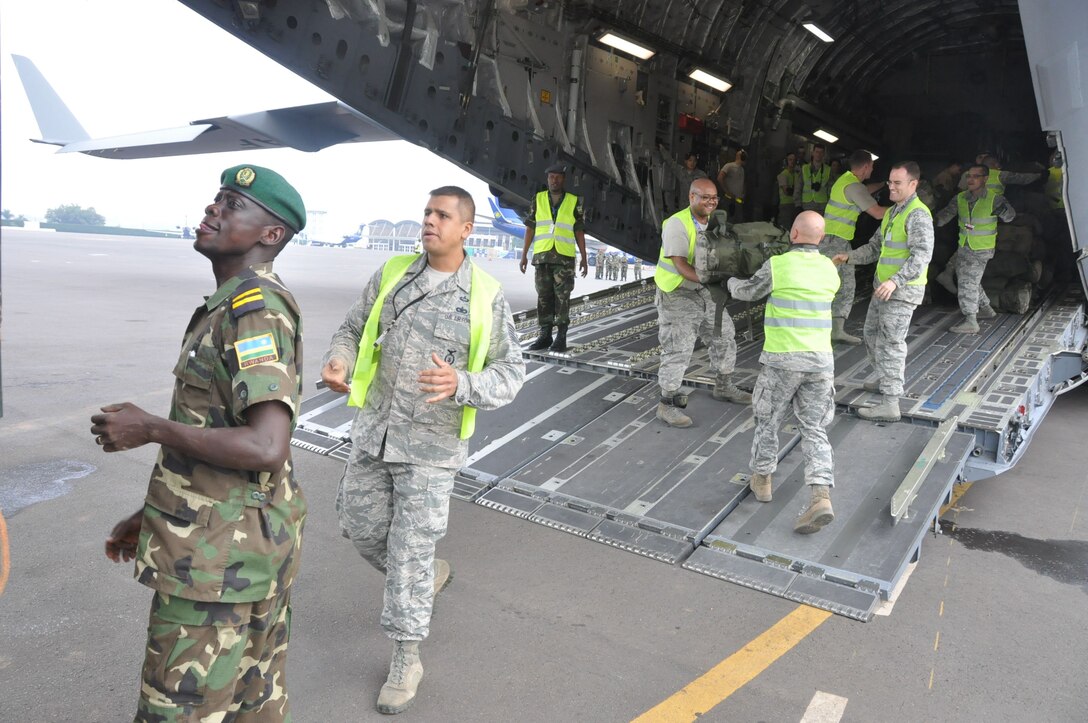 Members of the 435th Contingency Response Element and Rwandan soldiers load cargo onto a C-17 Globemaster III at Kigali International Airport, Rwanda, while supporting peace keeping operations in the Central African Republic Jan. 16, 2014.  Airmen from the 435th Air Ground Operations Wing’s Contingency Response Group responded to a request from France and the African Union for U.S. support to move Rwandan forces into the region. (Courtesy photo)