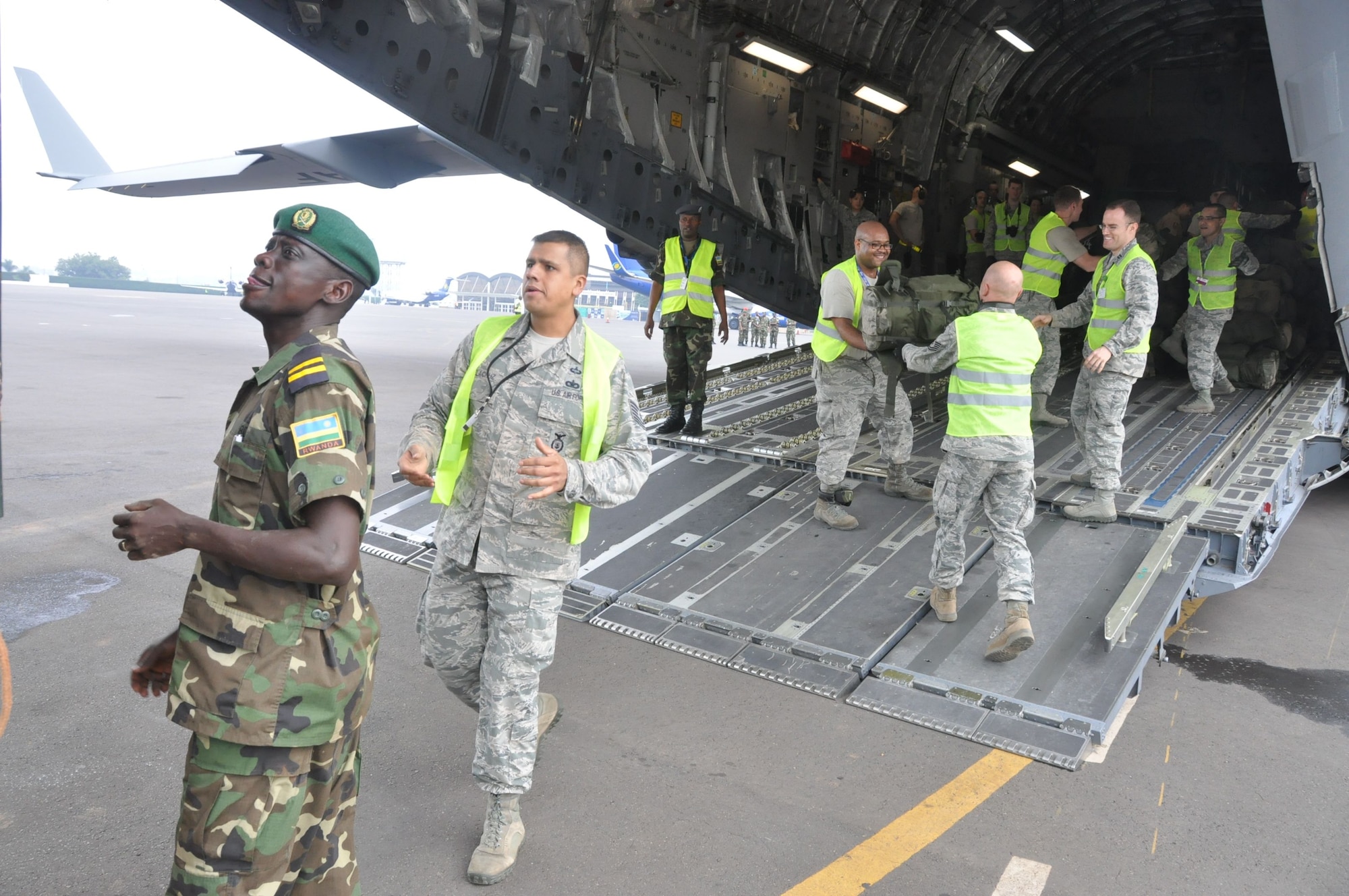 Members of the 435th Contingency Response Element and Rwandan soldiers load cargo onto a C-17 Globemaster III at Kigali International Airport, Rwanda, while supporting peace keeping operations in the Central African Republic Jan. 16, 2014.  Airmen from the 435th Air Ground Operations Wing’s Contingency Response Group responded to a request from France and the African Union for U.S. support to move Rwandan forces into the region. (Courtesy photo)