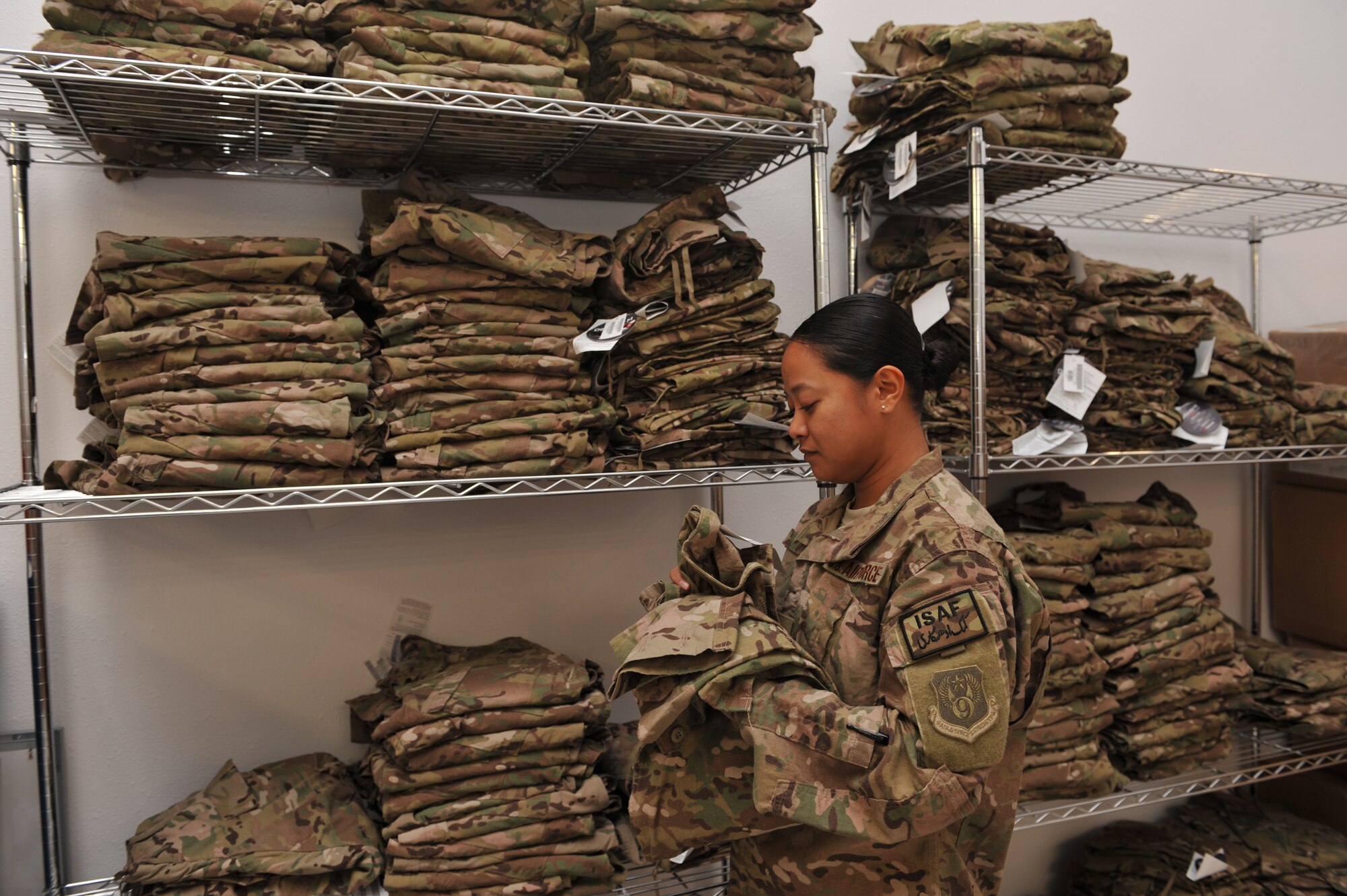 Master Sgt. Rosita Grubbs inventories Operation Enduring Freedom Camouflage Pattern uniforms at the 466th Air Expeditionary Group at Al Udeid Air Base, Qatar, Jan. 30, 2014. The 466th AEG recently moved from the Transit Center at Manas, Kyrgyzstan to Al Udeid Air Base, Qatar and provides administrative and operational control of all Joint Expeditionary Tasked Airmen and Individual Augmentee Airmen assigned to non-Air Force units executing joint mission sets in support of OEF operations throughout Central Commands area of operation. Grubbs is deployed from Tinker Air Force Base, Okla., and a San Antonio, Texas native. (U.S. Air Force photo by Master Sgt. David Miller)