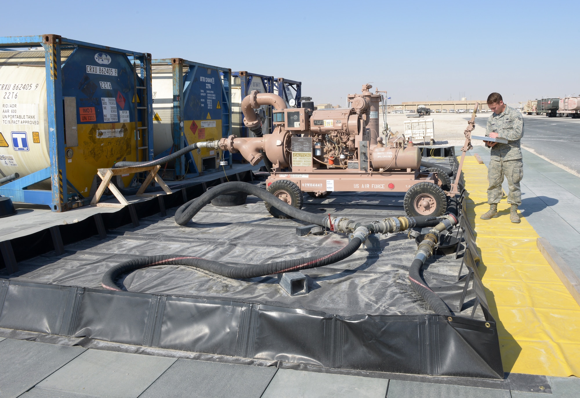 Senior Airman Adam Ranney records that all equipment is operational after the daily inspection of the emergency aviation gasoline equipment at Al Udeid Air Base, Qatar, Jan. 27, 2014. The 379th Expeditionary Logistics Readiness Squadron petroleum, oil and lubricants flight is the only location in the U.S. Air Forces Central Command area of responsibility capable of providing fly away emergency aviation gasoline and must be ready to deploy fuel 24/7/365.  Ranney is a 379th ELRS POL fuels ramp specialist deployed from Ramstein Air Base, Germany, and a Whittier, Calif., native.  (U.S. Air Force photo/Senior Airman Hannah Landeros)