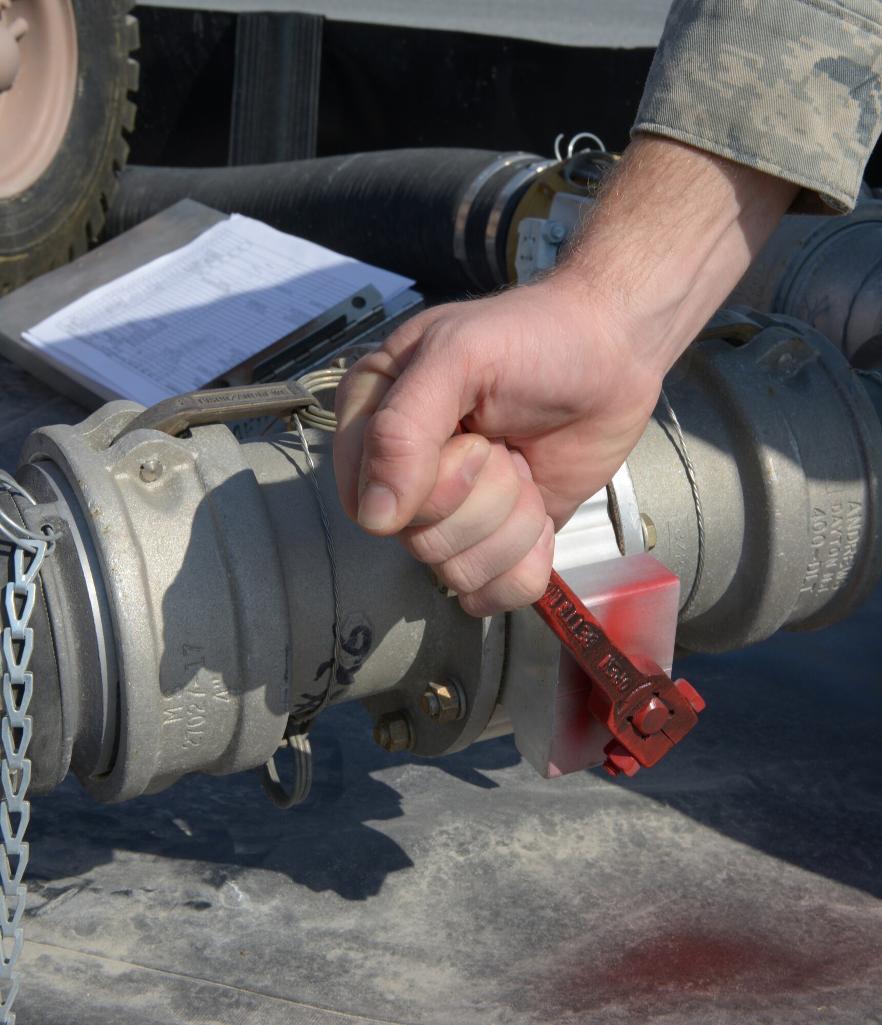 Senior Airman Adam Ranney conducts a daily inspection of a valve on the emergency aviation gasoline equipment at Al Udeid Air Base, Qatar, Jan. 27, 2014. The 379th Expeditionary Logistics Readiness Squadron petroleum, oil and lubricants flight is the only location in the U.S. Air Forces Central Command area of responsibility capable of providing fly away emergency aviation gasoline and must be ready to deploy fuel 24/7/365.  Ranney is a 379th ELRS POL fuels ramp specialist deployed from Ramstein Air Base, Germany, and a Whittier, Calif., native. (U.S. Air Force photo/Senior Airman Hannah Landeros)