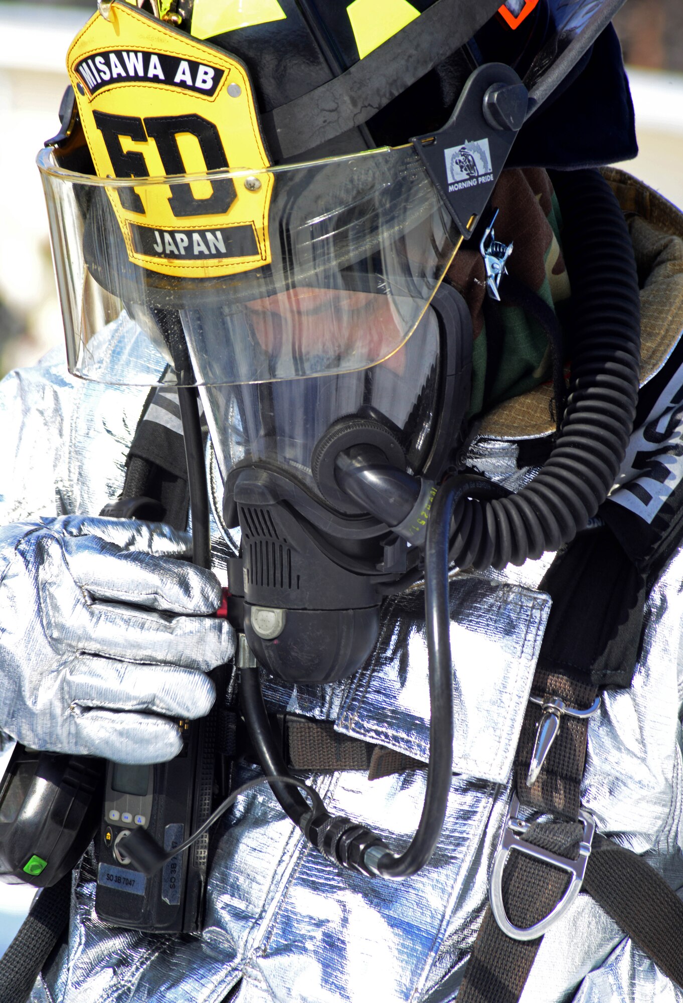 U.S. Air Force Airman 1st Class Benny Bowen, 35th Civil Engineer Squadron firefighter, listens as a call comes over the radio about two down Airmen left in a burning building after a simulated attack during Phase II of the operational readiness exercise on Misawa Air Base, Japan, Jan. 29, 2014.  After arriving on the scene of a simulated attack the firefighters are prepared to enter the smokey death trap and recover any wingmen that couldn't make it out. (U.S. Air Force photo/Tech. Sgt. April Quintanilla)