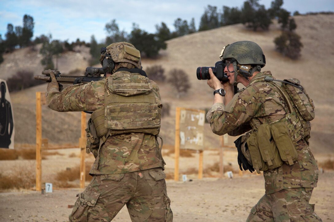 Army Spc. Steven Hitchcock, right, takes photographs of Army Rangers during close quarter marksmanship qualifications at a range on Fort Hunter Liggett, Calif., Jan. 25, 2014. Hitchcock, a combat photographer, is assigned to 55th Signal Company Combat Camera, Fort Meade, Md. 