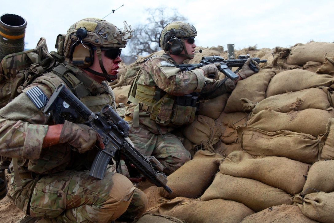 Army Rangers get on line to provide security and lay down suppressive fire during a live-fire exercise on Fort Hunter Liggett, Calif., Jan. 25, 2014. The Rangers are assigned to Company D, 2nd Battalion, 75th Ranger Regiment.