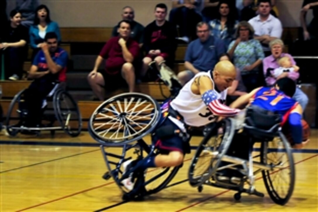 Retired Marine Josue Barron attempts to steal the ball from a player in San Diego, Jan. 25, 2014. Barron is a member of the Naval Medical Center San Diego Wolfpack wheelchair basketball team. The Wolfpack, which includes military and civilian members, is one of 10 teams in the West Coast Conference of the National Wheelchair Basketball Association.