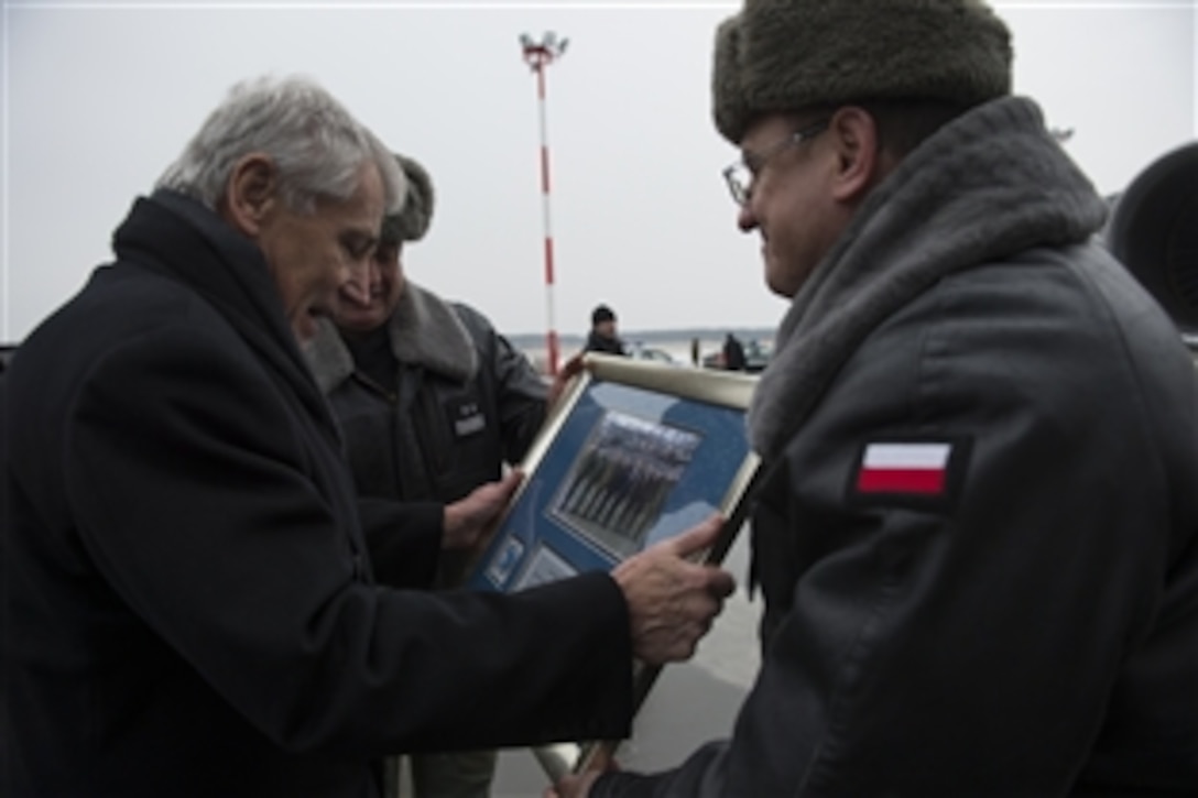 U.S. Defense Chuck Hagel recieves a gift from Polish airmen on Powidz Air Base, Poland, Jan. 31, 2014. Hagel is on a trip to Europe to meet with defense leaders and attend the 50th Munich Security Conference.