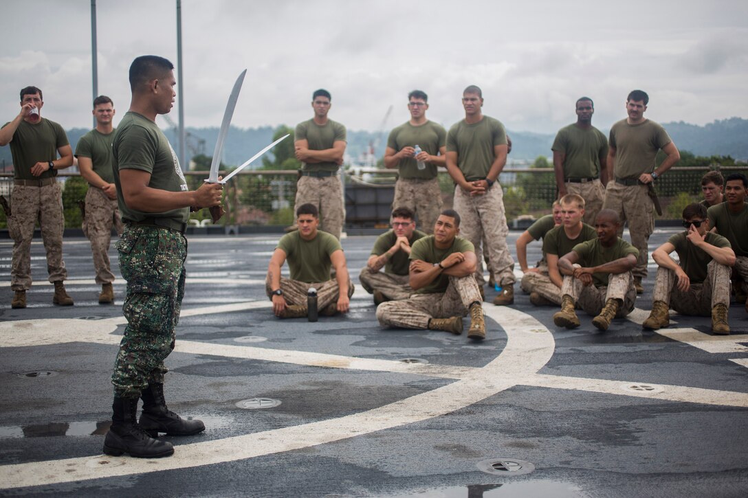 Philippine Marine Master Sgt. Manuel Prado, blademaster assigned to Marine Training Exercise Unit, demonstrates proper blade handling techniques to U.S. Marines assigned to Bravo Company, 1st Battalion, 8th Marine Regiment, during Cooperation Afloat Readiness and Training (CARAT) Philippines 2014.  In its 20th year, CARAT is an annual, bilateral exercise series with the U.S. Navy, U.S. Marine Corps and the armed forces of nine partner nations including Bangladesh, Brunei, Cambodia, Indonesia, Malaysia, the Philippines, Singapore, Thailand and Timor-Leste.  (U.S. Marine Corps photo by Lance Cpl. Austin Schlosser/Released)
