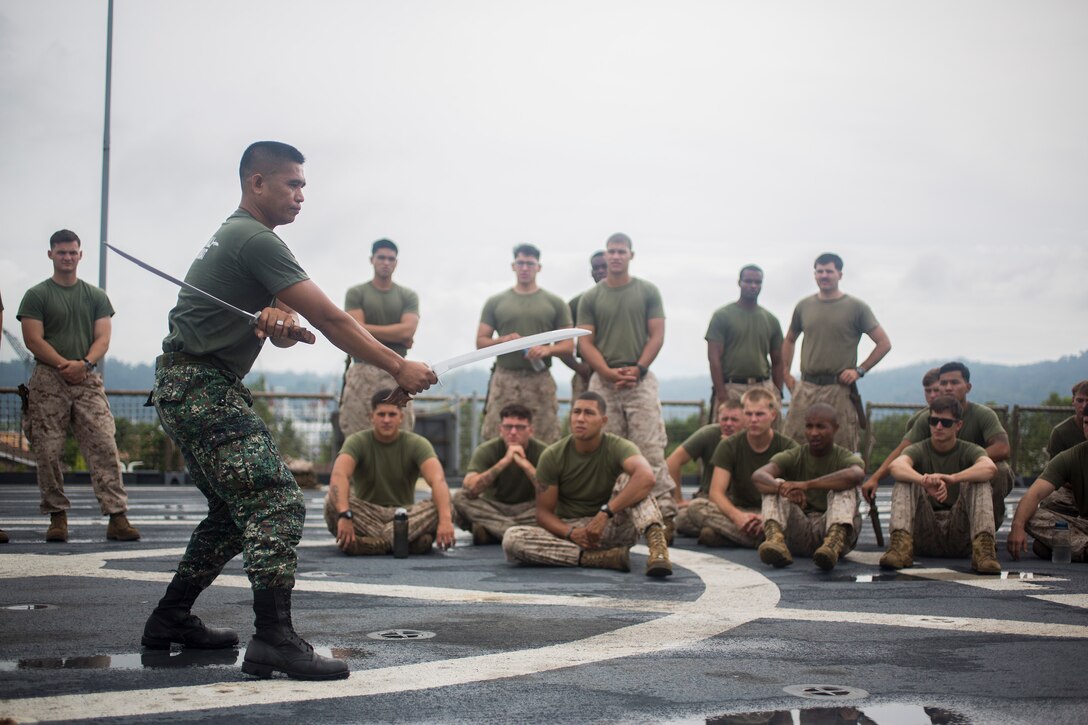 Philippine Marine Master Sgt. Manuel Prado, blademaster assigned to Marine Training Exercise Unit, demonstrates proper blade handling techniques to U.S. Marines assigned to Bravo Company, 1st Battalion, 8th Marine Regiment, during Cooperation Afloat Readiness and Training (CARAT) Philippines 2014.  In its 20th year, CARAT is an annual, bilateral exercise series with the U.S. Navy, U.S. Marine Corps and the armed forces of nine partner nations including Bangladesh, Brunei, Cambodia, Indonesia, Malaysia, the Philippines, Singapore, Thailand and Timor-Leste.  