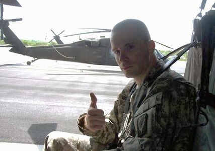 Sgt. Dennis Weichel Jr., a Rhode Island Army National Guard infantryman mobilized with Company C, 1st Battalion, 143rd Infantry Regiment, sits inside a Black Hawk helicopter prior to a mission earlier in his deployment in Afghanistan. Weichel died March 22, 2012, from injuries he sustained when he was struck by a mine-resistant, ambush-protected vehicle, or MRAP, after moving an Afghan child to safety.