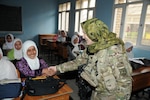 Army Lt. Col. Robyn Blader, a staff judge advocate team member with Task Force Hyrda, Georgia National Guard, speaks with Gulnaz, an eighth grade student, at the Darulaman school in Kabul, Afghanistan. Gulnaz told Blader that she would wants to study literature in college.