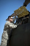 Army Chief Warrant Officer 2 Jonathan Sigl performs a pre-flight inspection on an OH-58 Kiowa aircraft in Marana, Ariz. Sigl is part of a North Dakota National Guard flight crew participating with Task Force Raven of the Southwest Border mission.