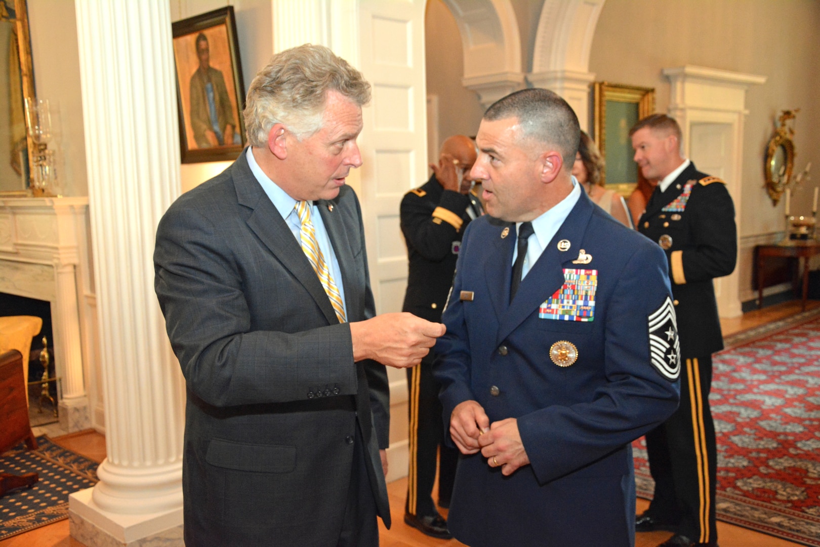 DIA’s Senior Enlisted Advisor Chief Master Sgt. Troy Eden talks with Virginia Gov. Terry McAuliffe during a reception with Virginia’s senior military leaders June 26. 