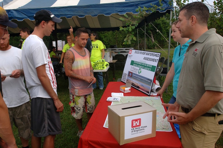Ramune Morales (Second from Right), project manager, and Craig Carrington (Far Right), chief of the Nashville District Planning Branch Plan Formulation Section, educate volunteers about the Duck River Watershed Assessment June 28, 2014 at River Bottom Park in Shelbyville, Tenn.