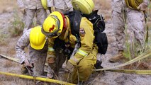 Marines with 2nd Battalion, 11th Marine Regiment, 1st Marine Division, I Marine Expeditionary Force, learn how to cut off water pressure while progressively laying hoses during a Woodland Firefighting Course aboard Marine Corps Base Camp Pendleton, Calif., June 26, 2014. The weeklong training was led by firefighters from the California Department of Forestry and Fire Protection and the Camp Pendleton Fire Department. (U.S. Marine Corps Photo by Lance Cpl. Tony Simmons)