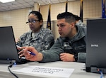 Army Spc. Cynthia Rivera (left) and Army Spc. Joshua Alicea, both with the 408th Human Resources Company, Fort Totten, N.Y., practice theater gateway operations as part of the culminating training event during the second week of the human resources annual training exercise, Silver Scimitar 2012. The 408th supports the 633rd Theater Gateway, an Illinois Army National Guard unit that will be the first National Guard unit to operate a combat theater gateway, moving troops into, and out of, theater. (U.S. Army photo by David Turner)