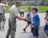 Staff Sgt. Jake Pudlick slaps hands with kids after a brief soccer game outside an elementary school in Ogulin, Croatia, June 18, 2014. The school bathrooms are being renovated by Airmen from the 133rd Civil Engineering Squadron, 148th Civil Engineering Squadron, and 219th Red Horse Squadron in partnership with the Croatian Army. (U.S. Air National Guard photo by Staff Sgt. Austen Adriaens)