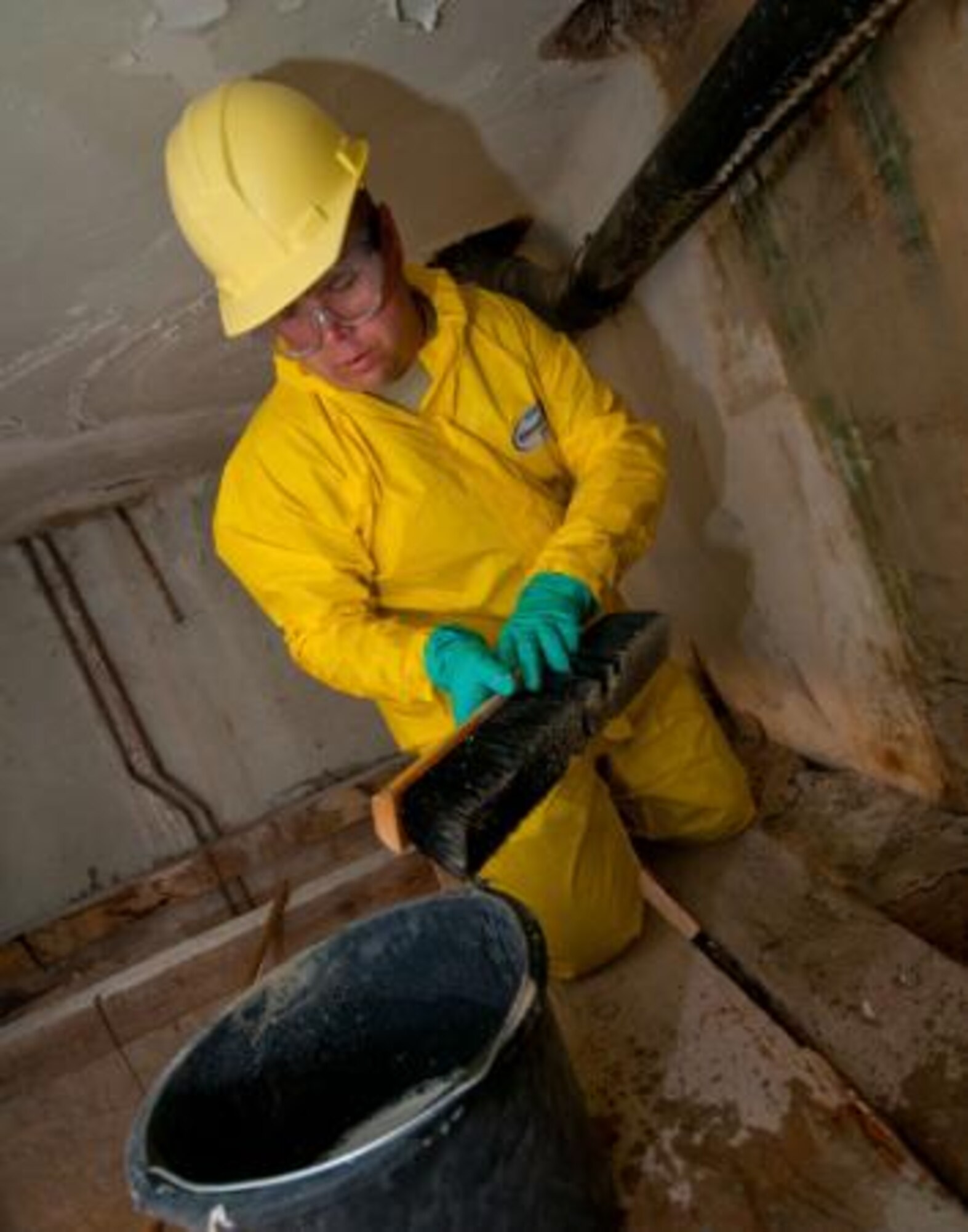 Chief Master Sgt. Kyle Johnson, 148th Civil Engineering Squadron, disinfects a bathroom wall at an elementary school in Ogulin, Croatia, June 19, 2014. The school bathrooms are being renovated by Airmen from the 133rd and 148th Civil Engineering Squadron, and 219th Red Horse Squadron in partnership with the Croatian Army, under the National Guard State Partnership Program. (U.S. Air National Guard photo by Staff Sgt. Austen Adriaens)