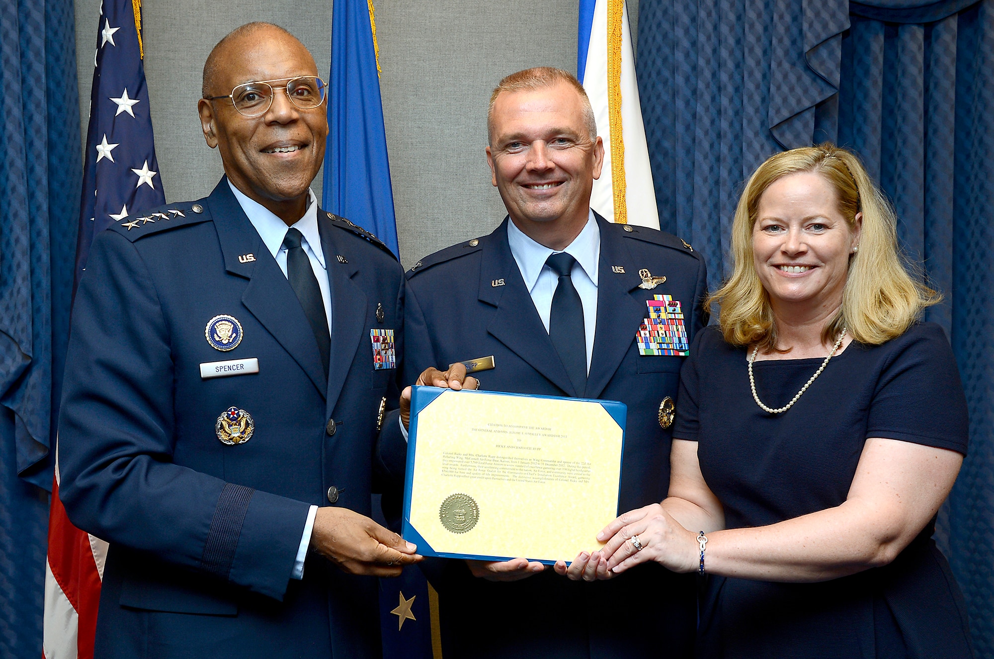 Air Force Vice Chief of Staff Gen. Larry O. Spencer presents Col. Ricky Rupp and his wife, Charlotte, with the 2013 General and Mrs. Jerome F. O'Malley Award June 27, 2014, during a Pentagon ceremony.  Rupp, the special assistant to the commander at U.S./Republic of Korea Combined Forces Command at U.S. Army Garrison Yongsan.  The award was earned during the Rupps' time while leading the 22nd Air Refueling Wing at McConnell Air Force Base, Kan.  (U.S. Air Force photo/Scott M. Ash)