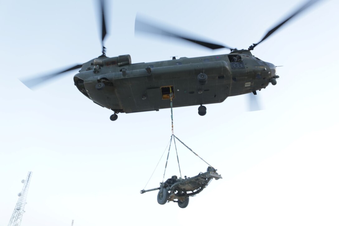 A CH-47 Chinook with the Joint Helicopter Support Squadron extracts an L-188 Light Gun and transports it from Main Operating Base (MOB) Price, to Camp Bastion, Helmand province, Afghanistan, June 30, 2014. The gun is being transferred from MOB Price, to Camp Bastion to provide additional support towards the redeployment of Coalition Forces. (Official U.S. Marine Corps photo by Cpl. James D. Pauly, Marine Expeditionary Brigade Afghanistan/Released)