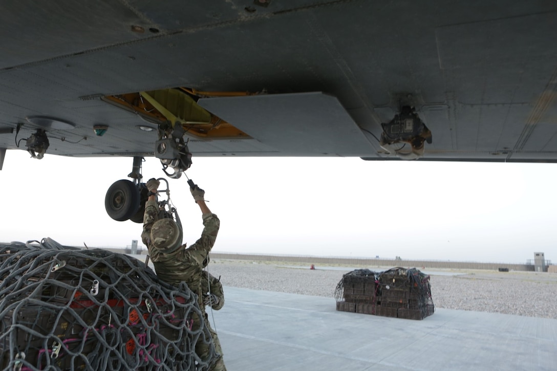 GDSM Karl Simonaitis and PTE Carson Howe with Joint Helicopter Support Squadron (JHSS), attach cargo to a CH-47 Chinook, aboard Main Operating Base (MOB) Price, Helmand province, Afghanistan, 30 June, 2014. The guns are being transferred from MOB Price, to Camp Bastion to support the redeployment of Coalition Forces. (Official U.S. Marine Corps photo by Cpl. James D. Pauly, Marine Expeditionary Brigade Afghanistan/Released)